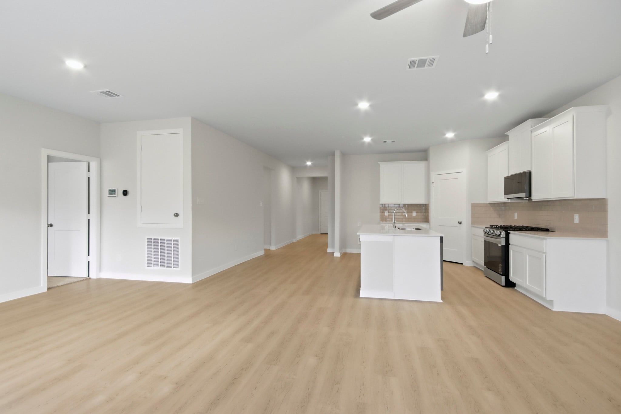 A large kitchen with white cabinets.