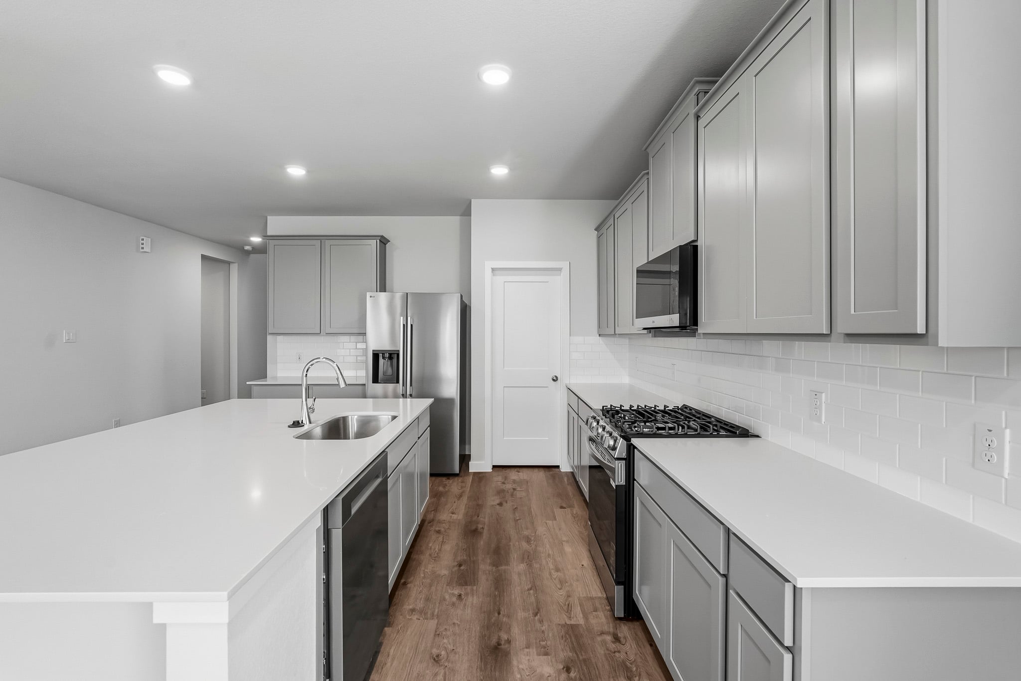 A kitchen with white cabinets.
