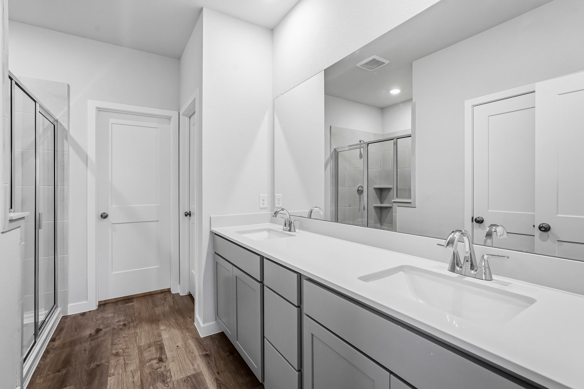 A bathroom with a large mirror.