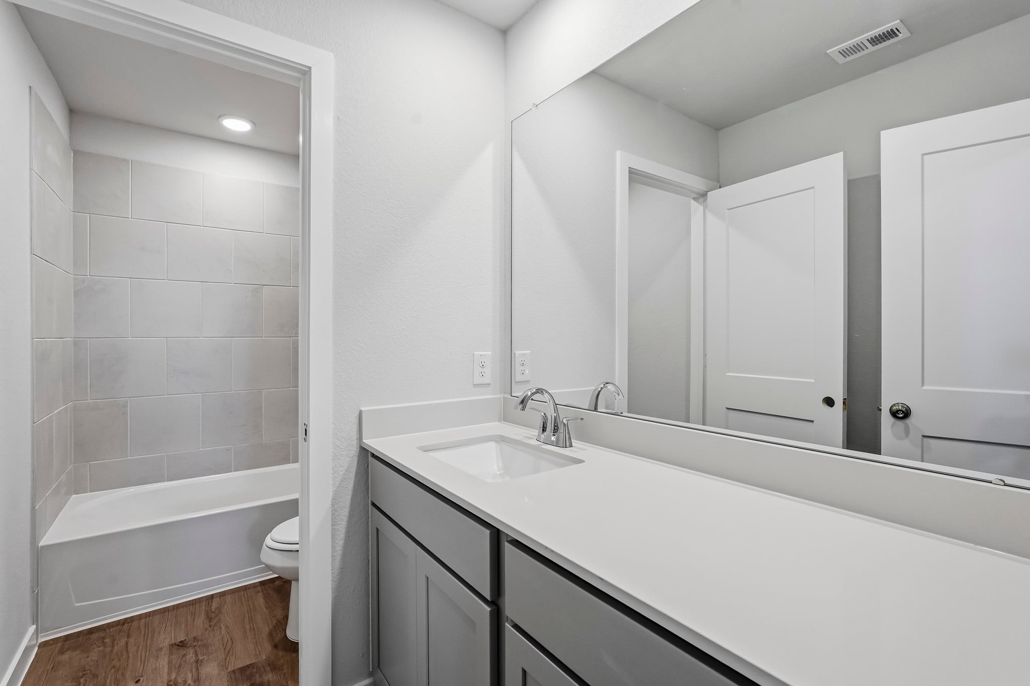 A bathroom with a tub sink and toilet.