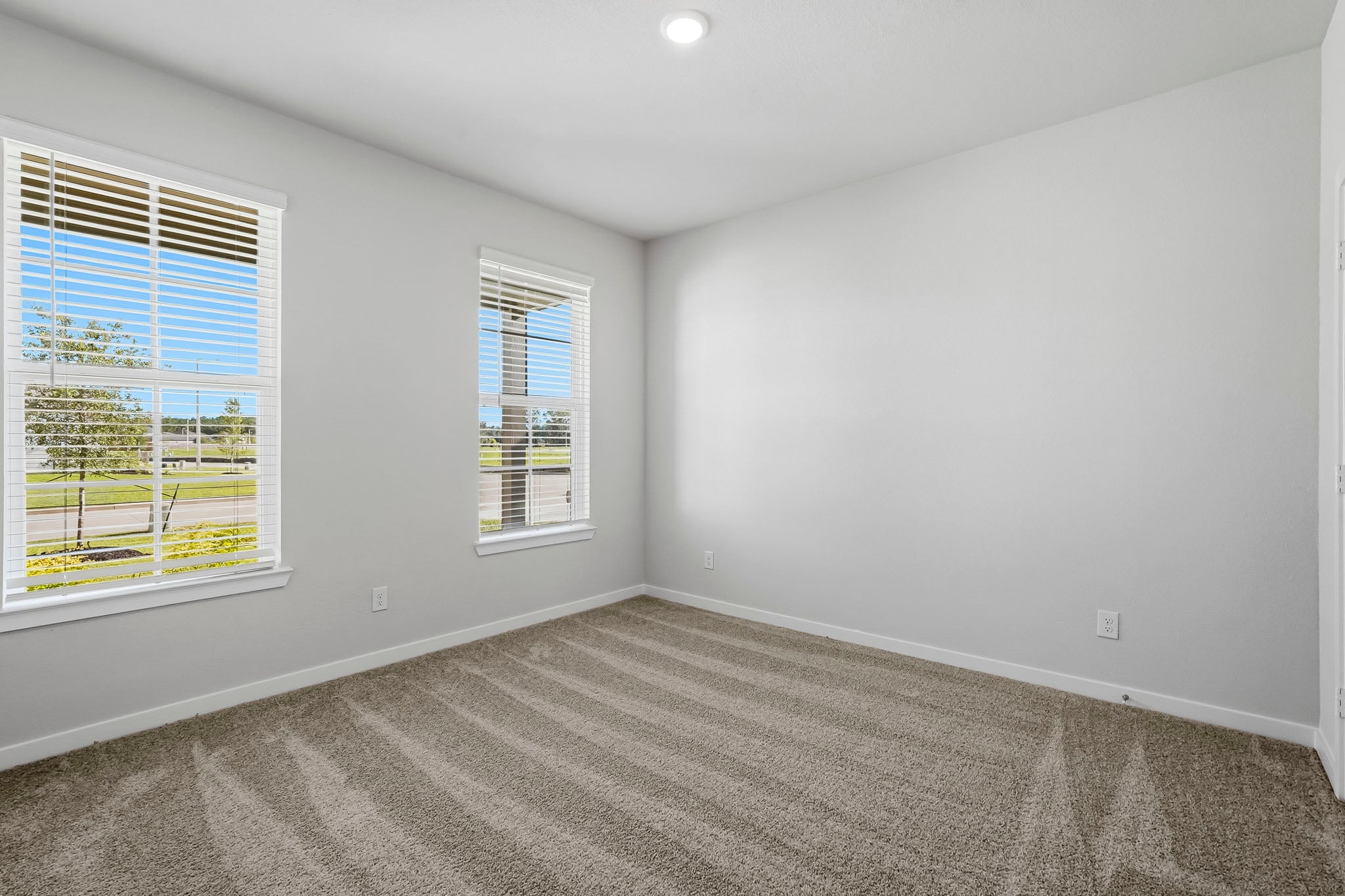 A room with a window and a carpet.