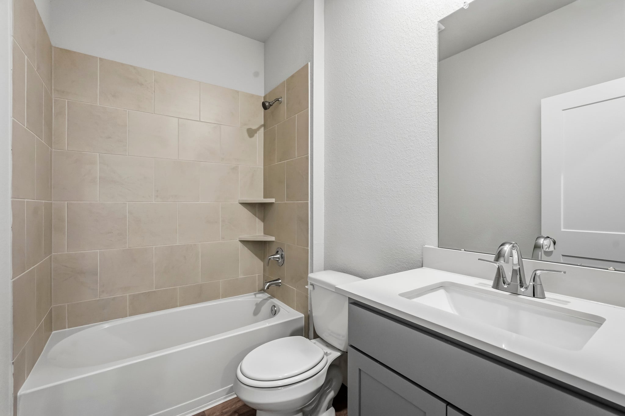A bathroom with a tub sink and toilet.