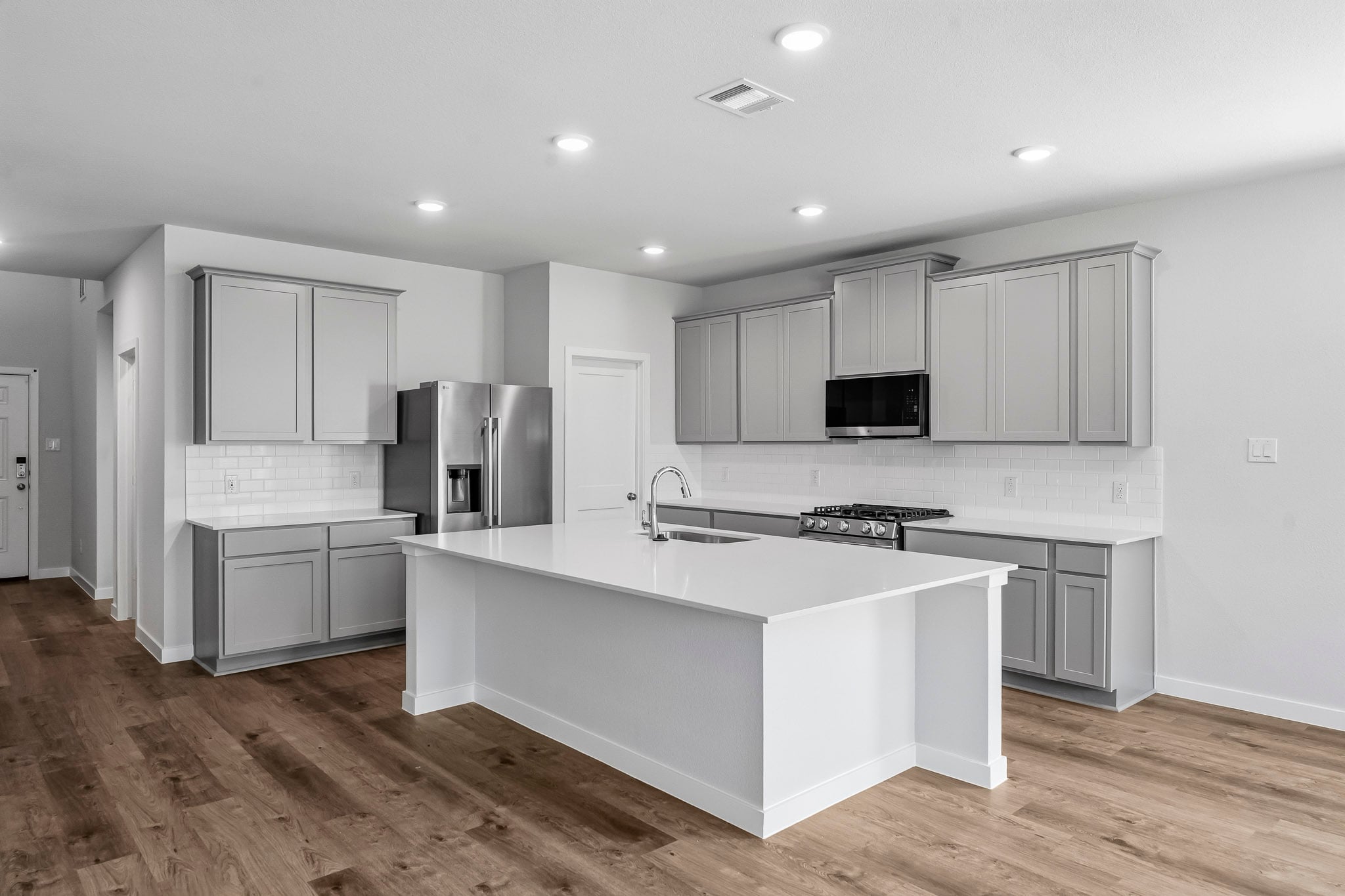 A kitchen with white cabinets.