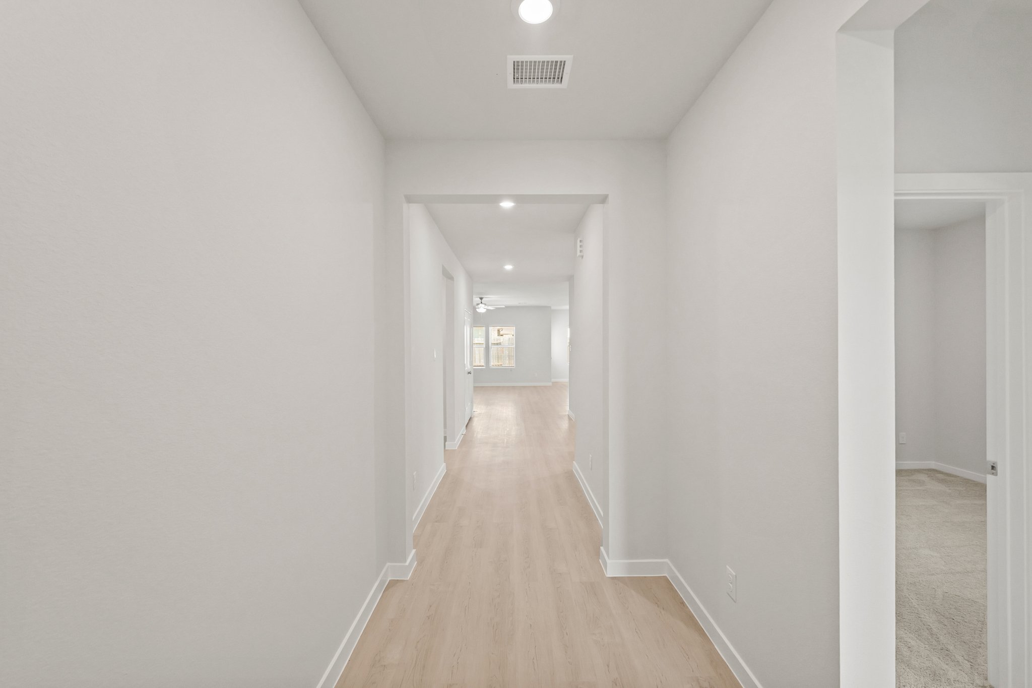 A long hallway with white walls.