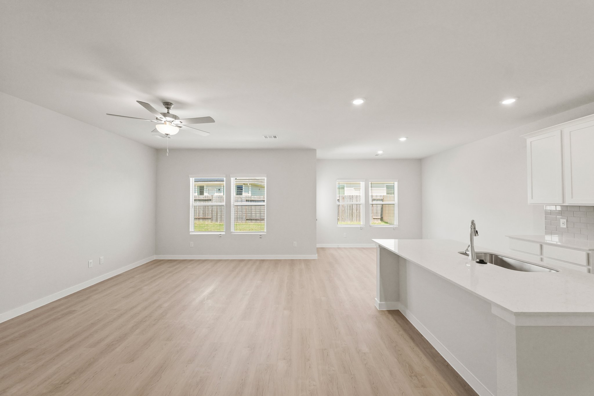 A large kitchen with a wood floor.