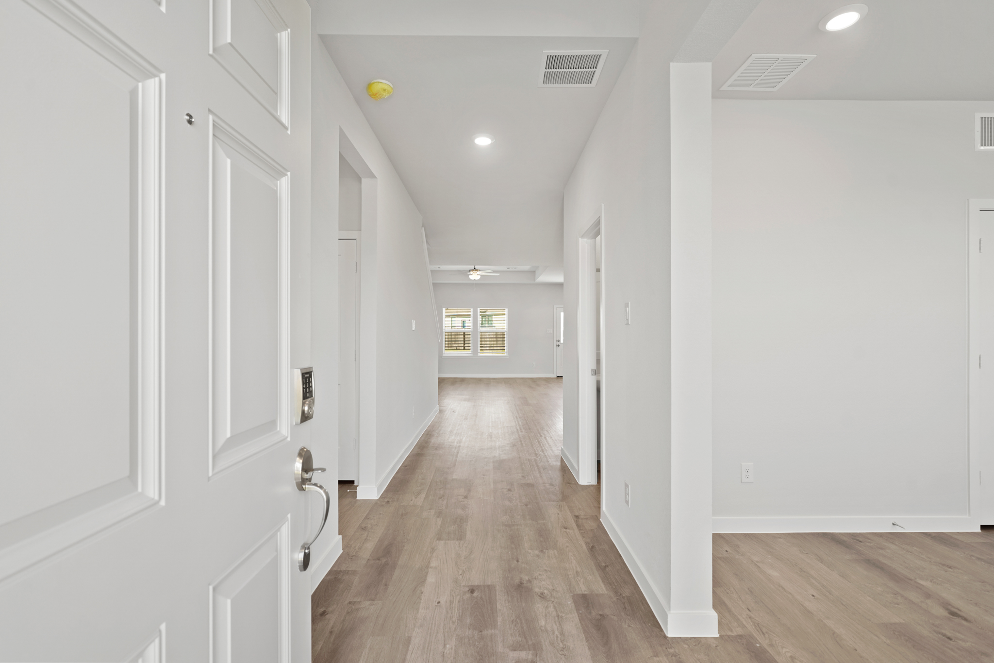 A hallway with white doors.