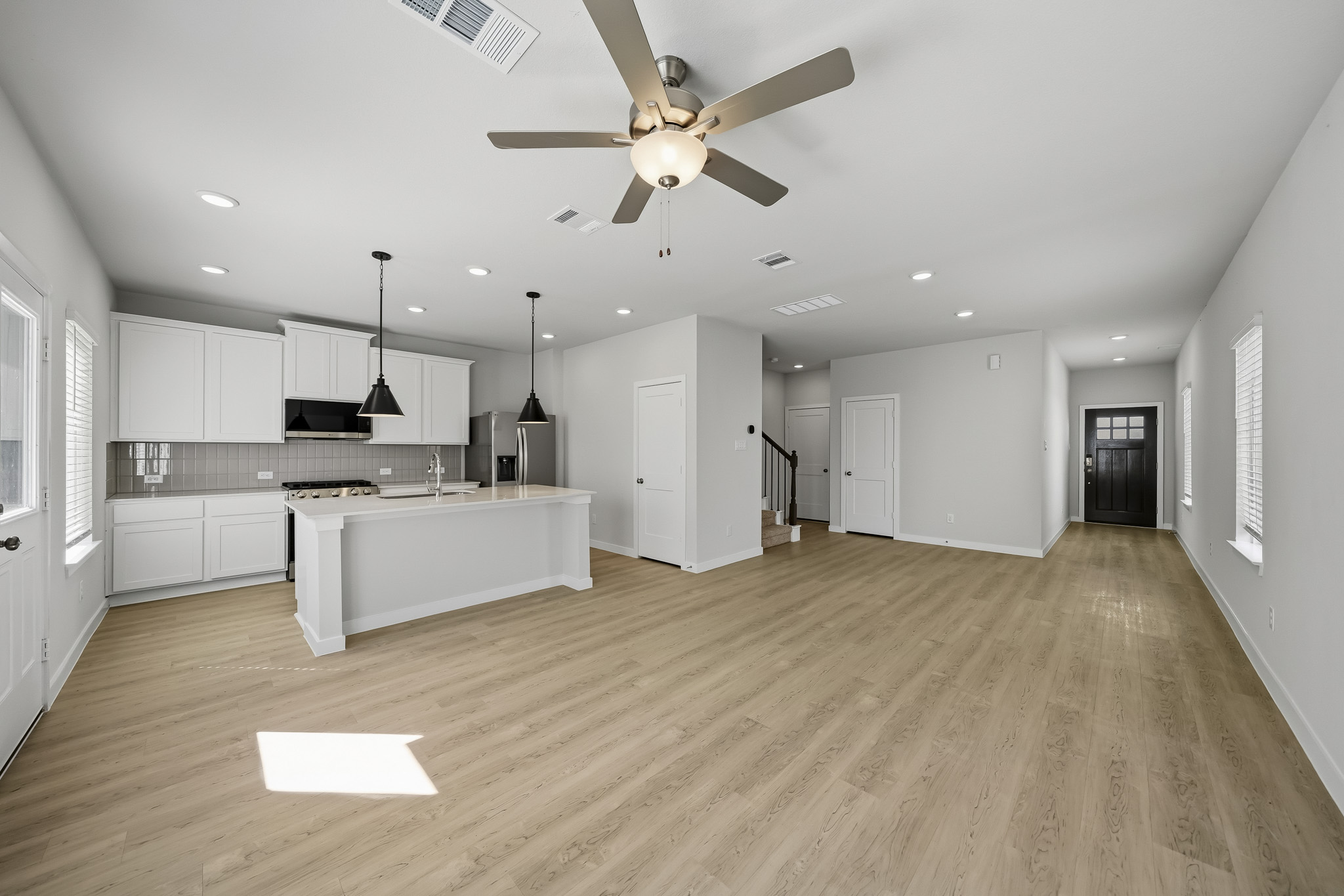 A large kitchen with white cabinets.