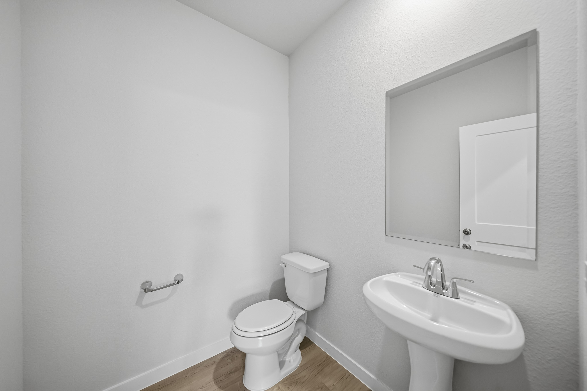A bathroom with a toilet and sink.