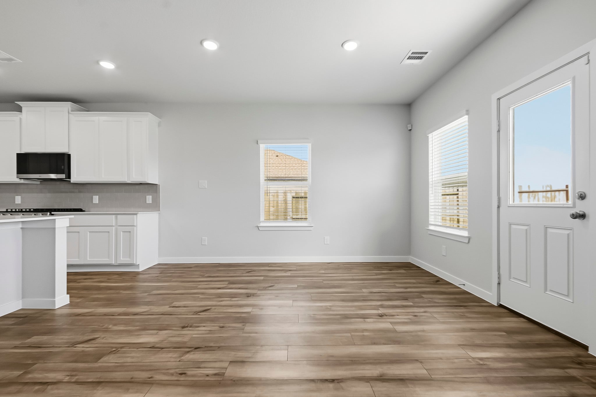 A kitchen with white cabinets.