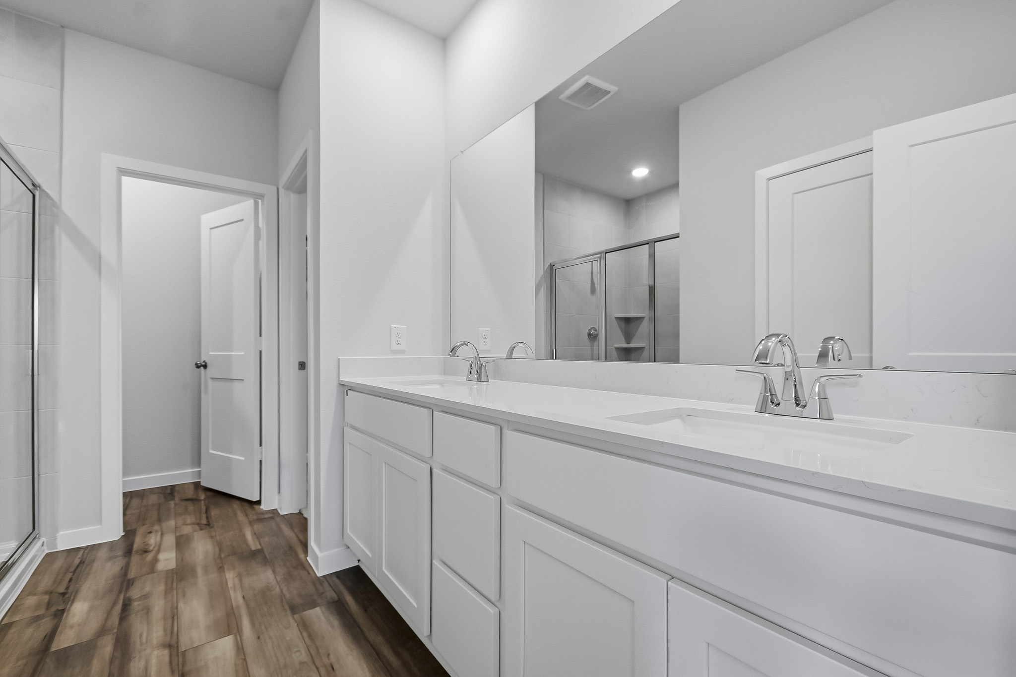 A bathroom with white cabinets.