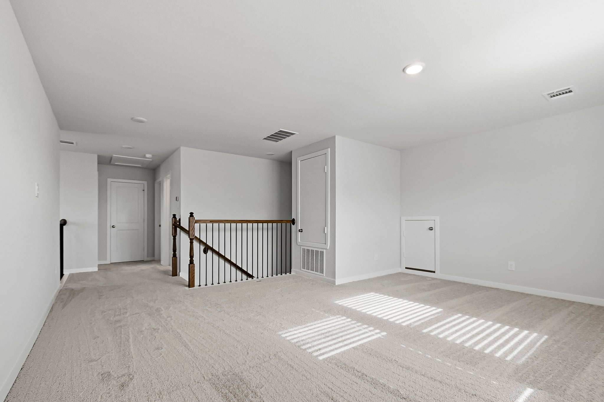 A room with a staircase and a railing.