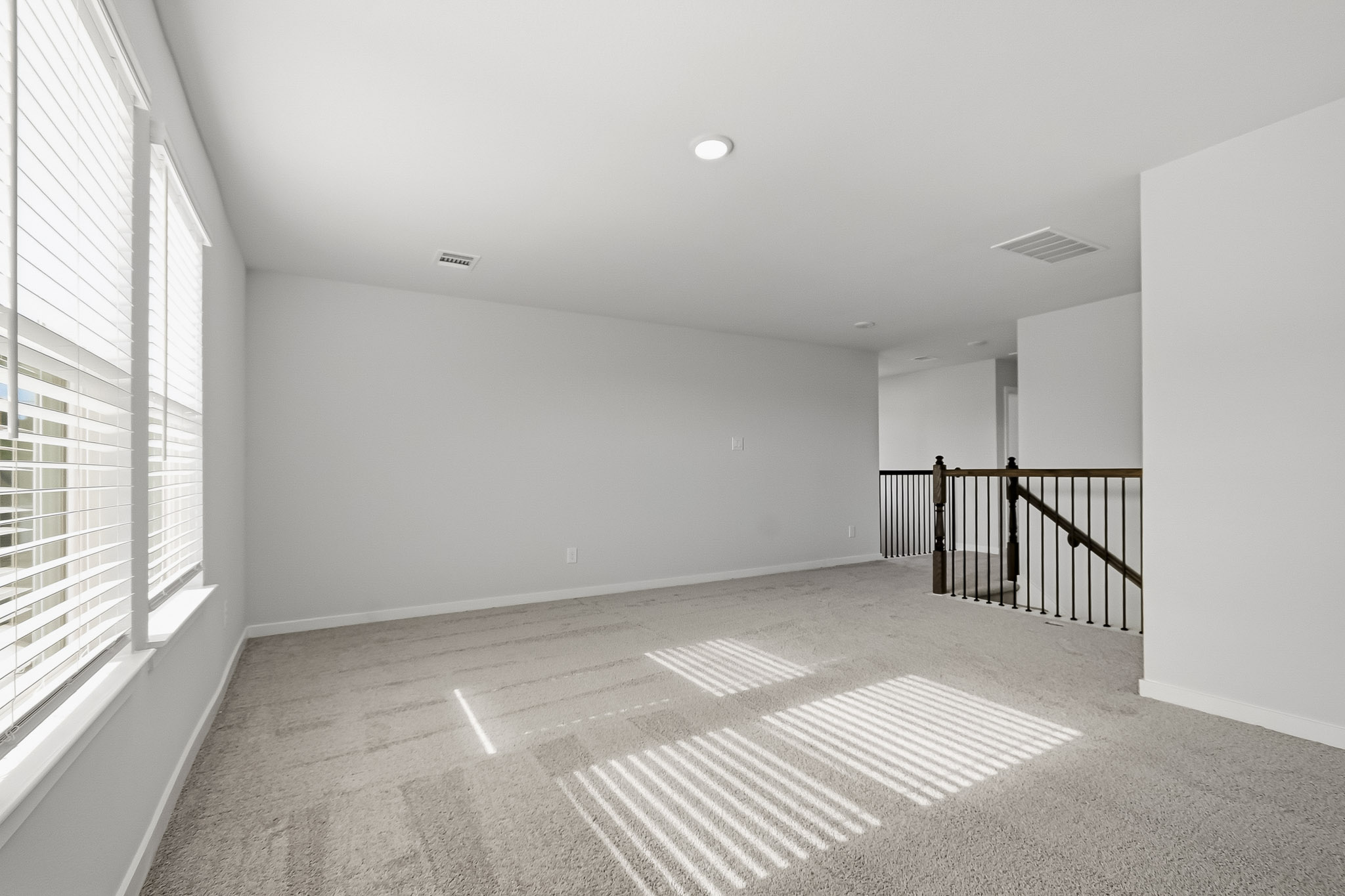 A hallway with a rug.