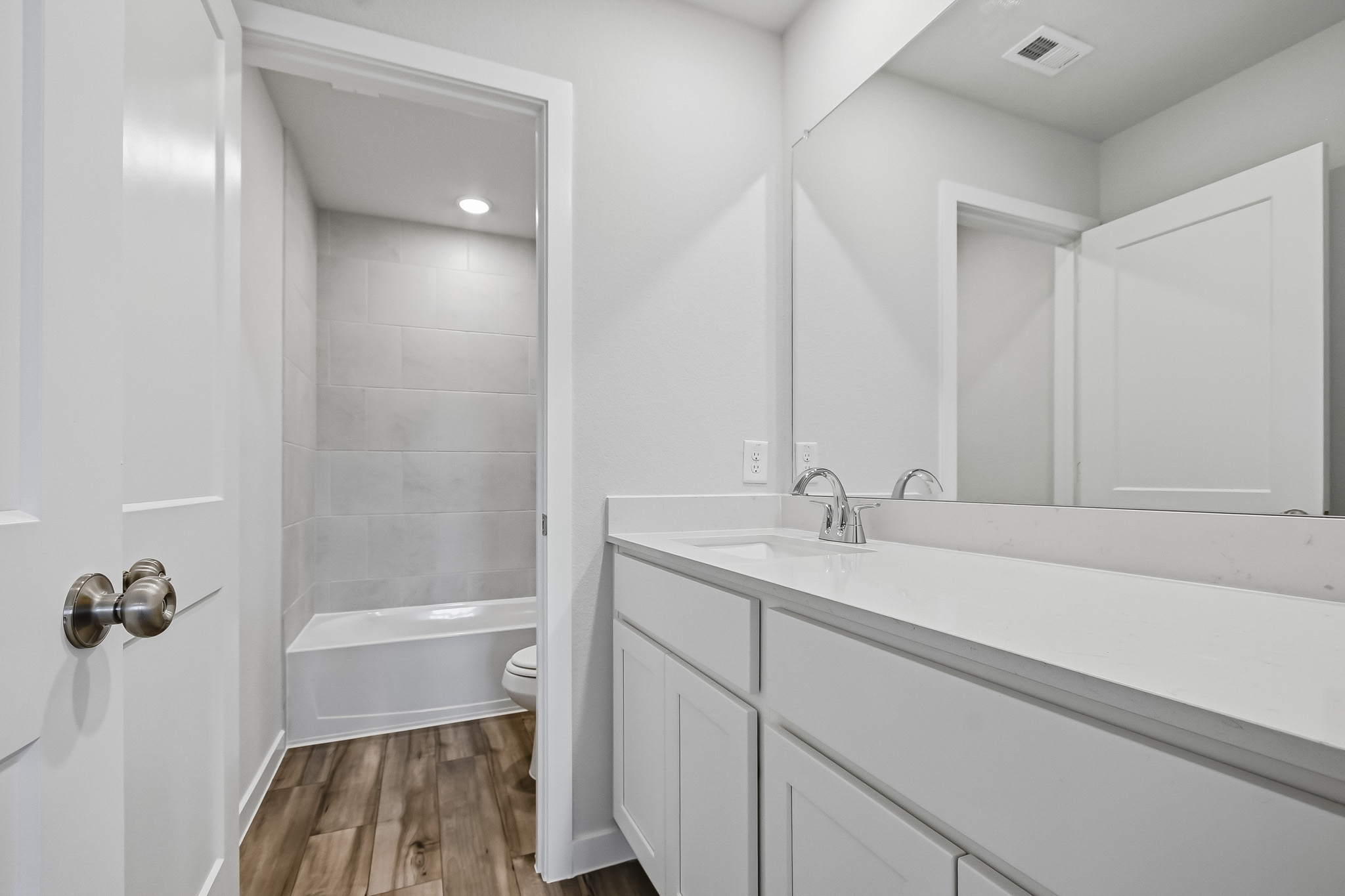 A bathroom with a tub sink and toilet.