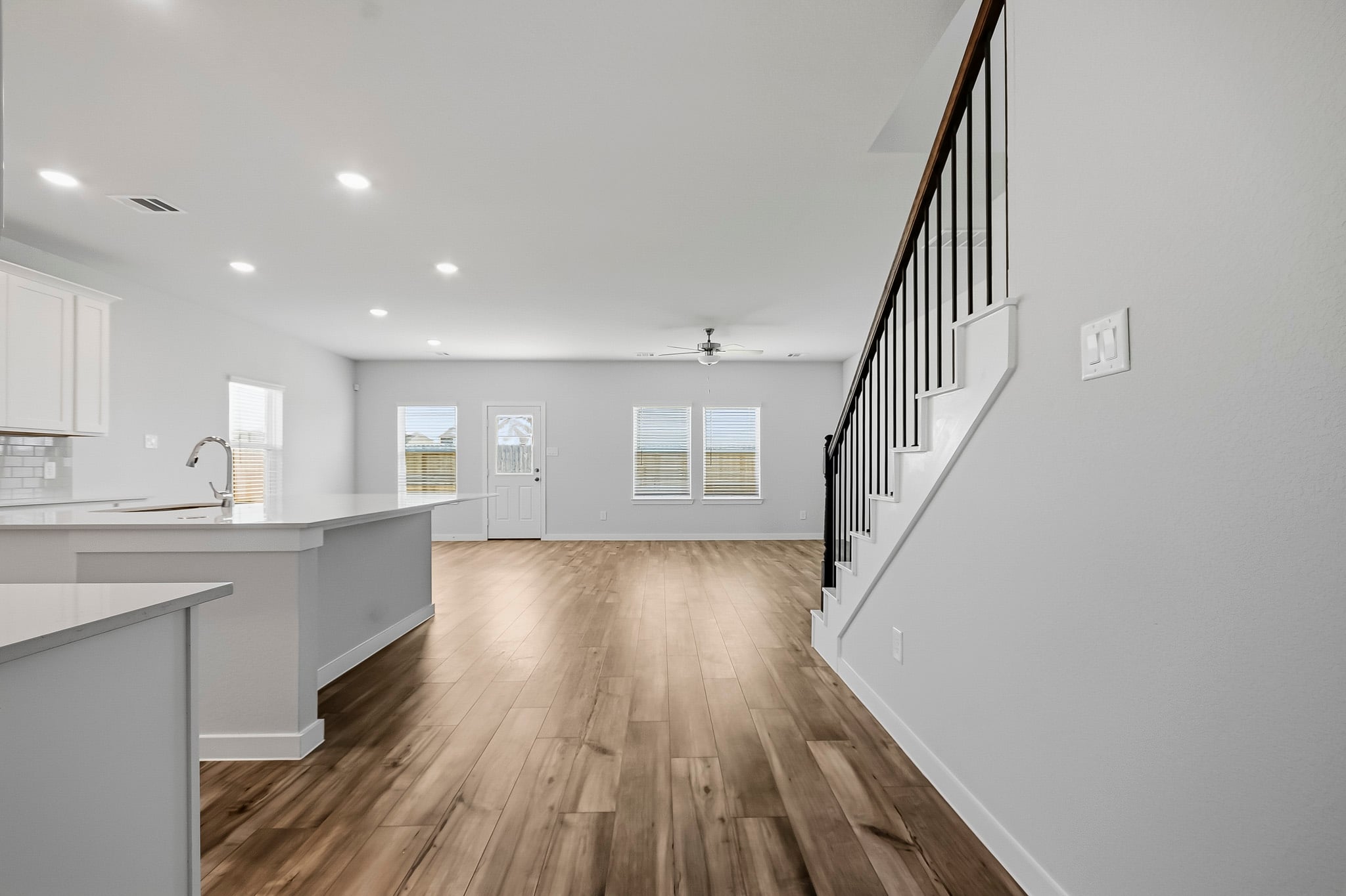A kitchen with white cabinets.
