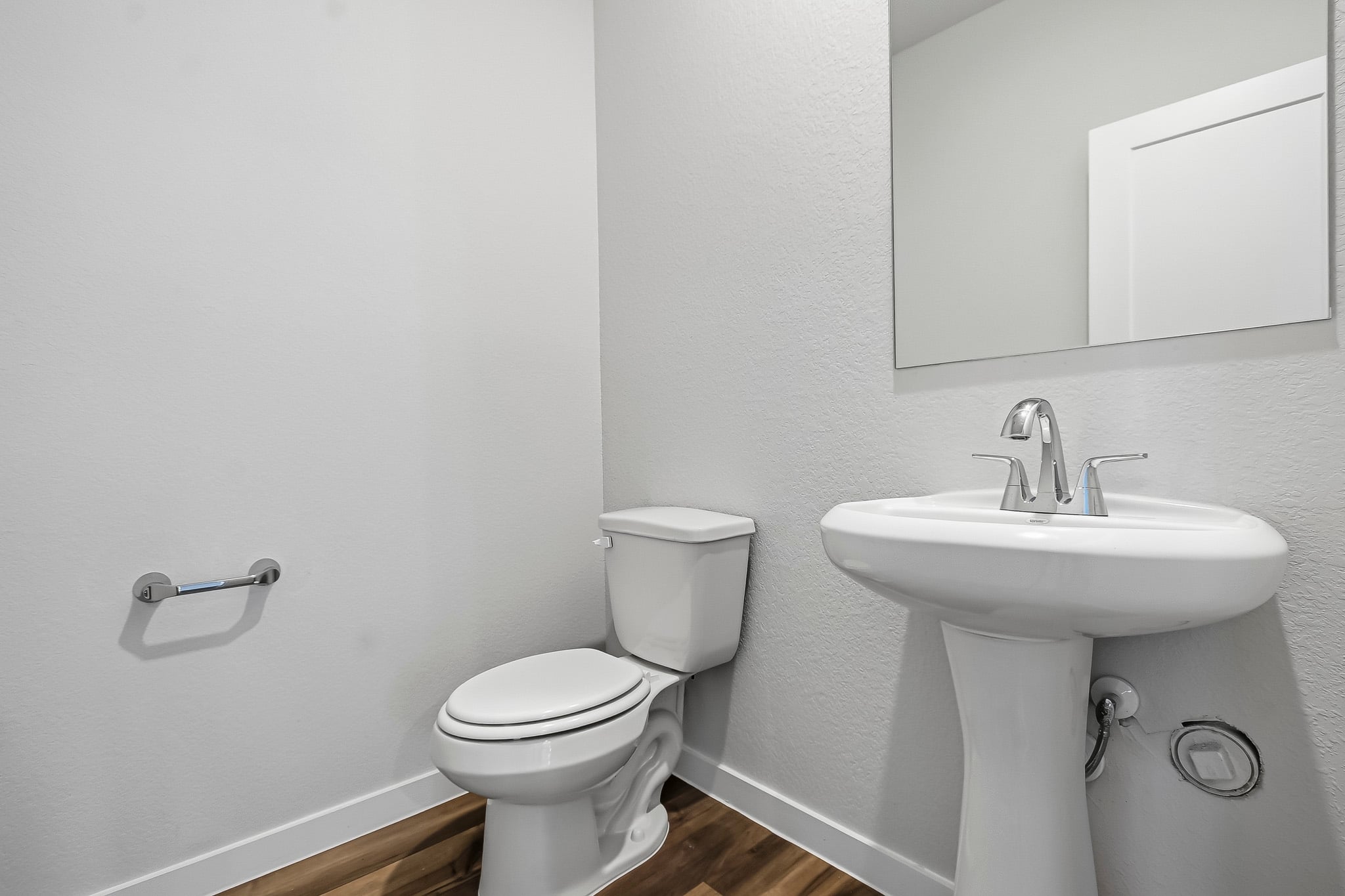 A bathroom with a toilet and sink.