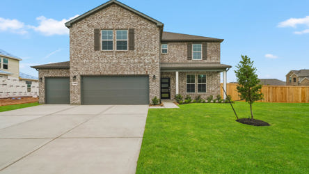 A house with a garage and a lawn.