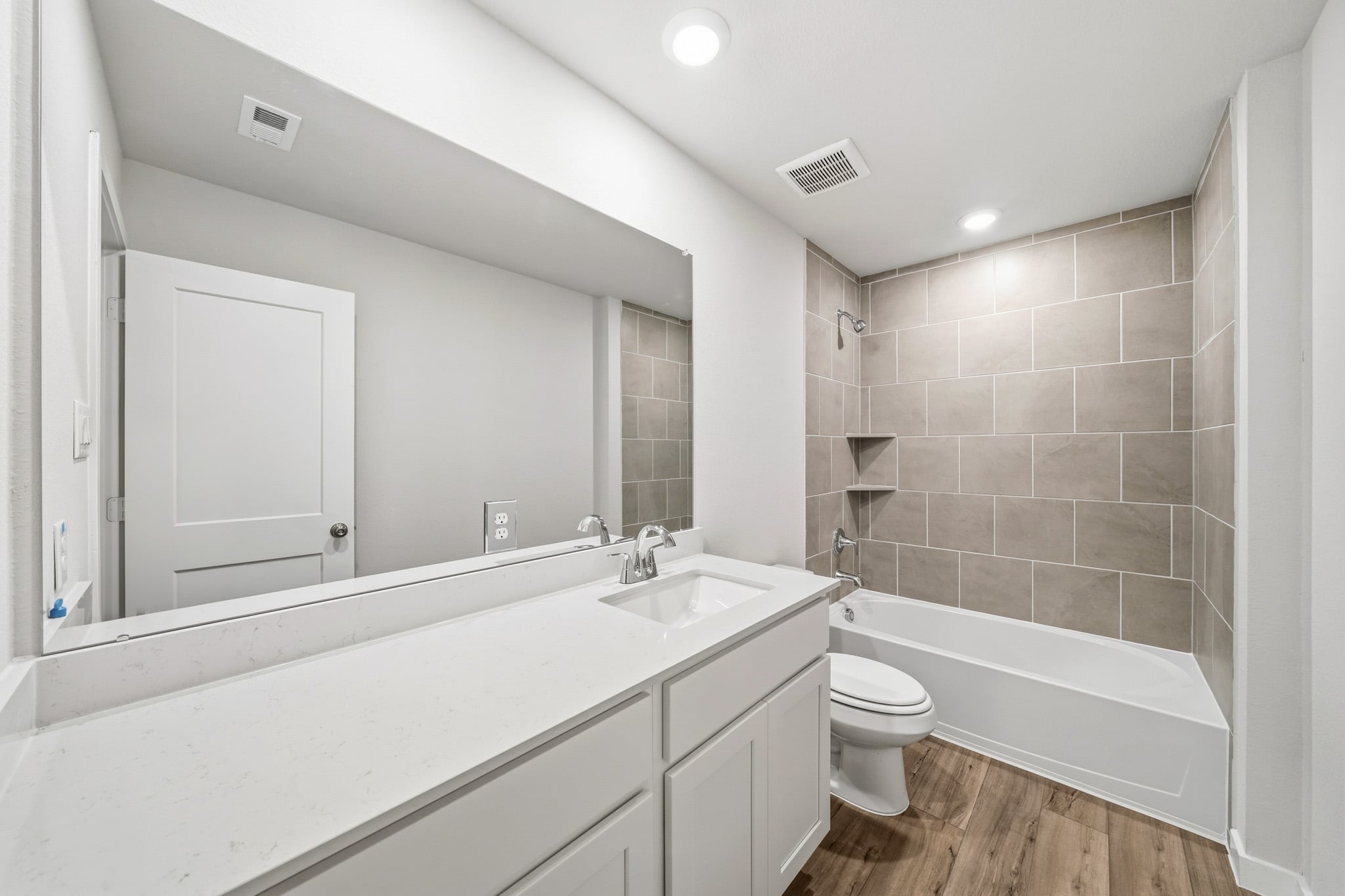 A bathroom with a tub sink and toilet.