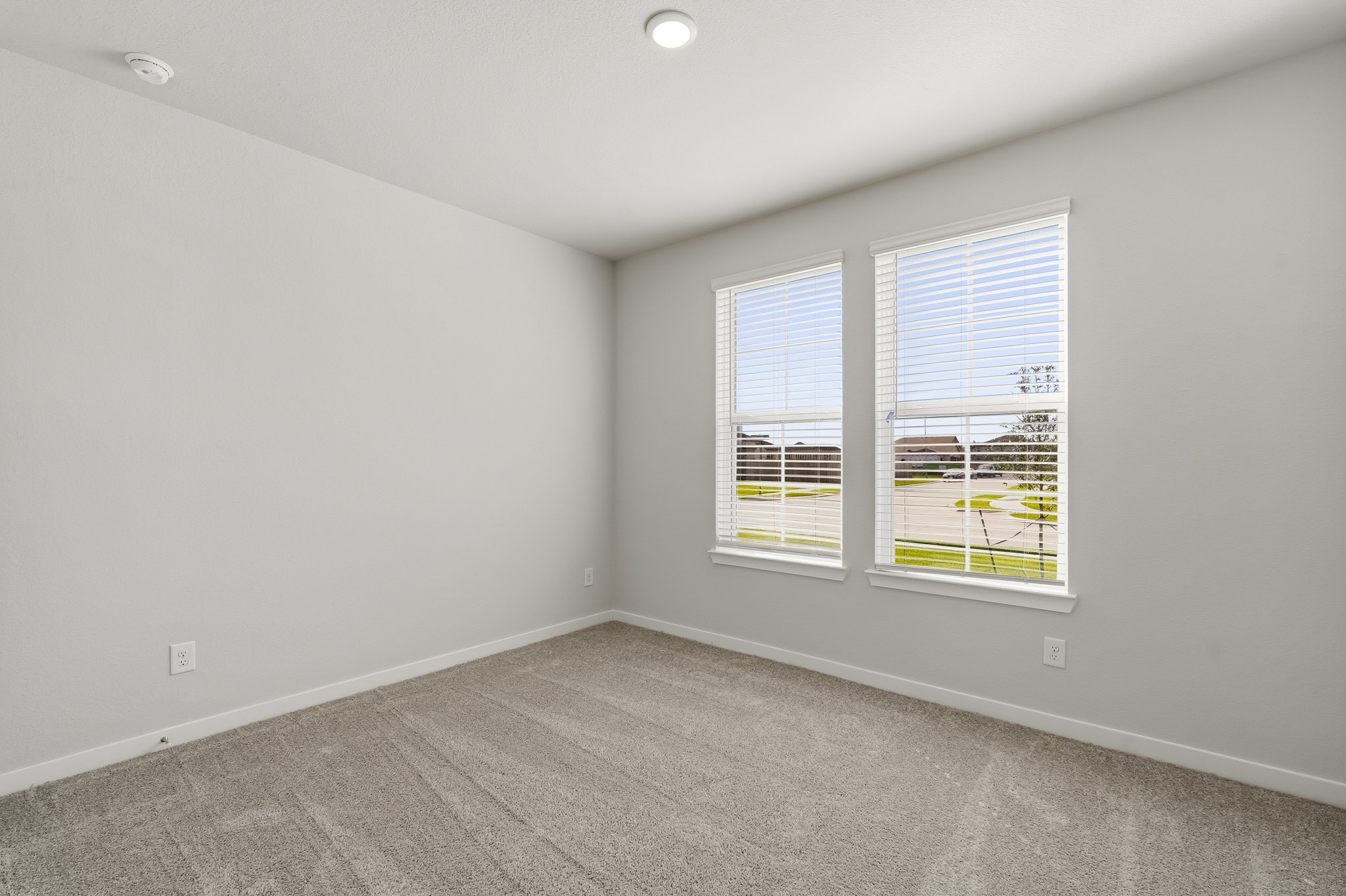 A room with a window and a carpet.