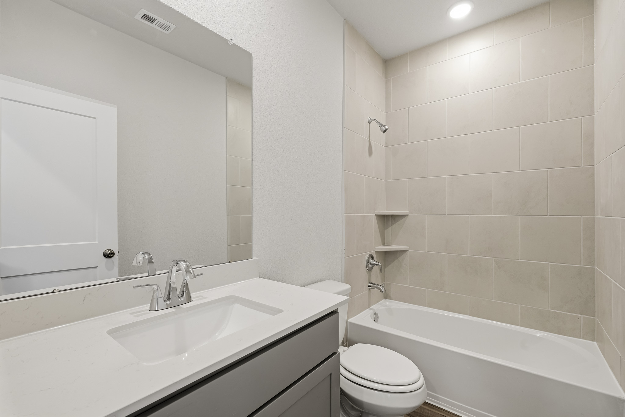 A bathroom with a tub sink and toilet.