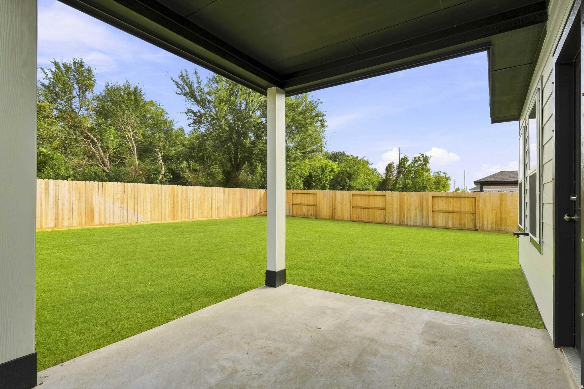 A backyard with a fence and a wood fence.