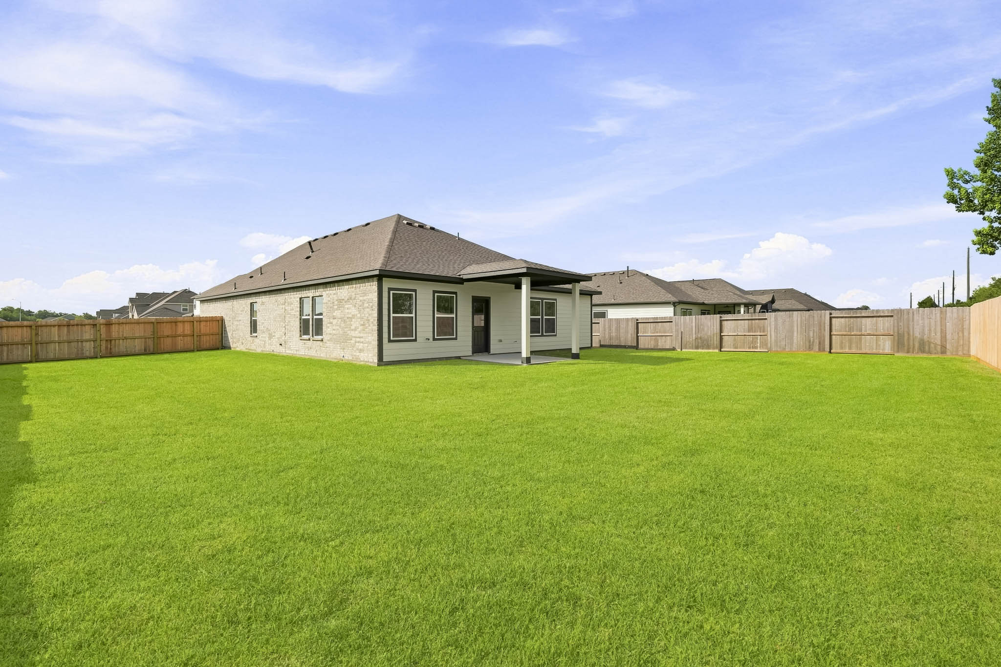 A large green lawn in front of a house.