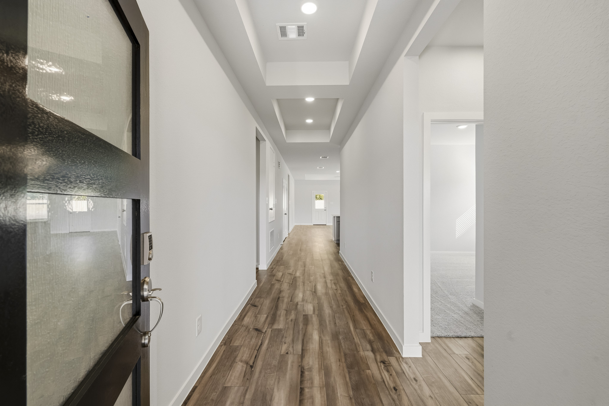 A hallway with white walls.