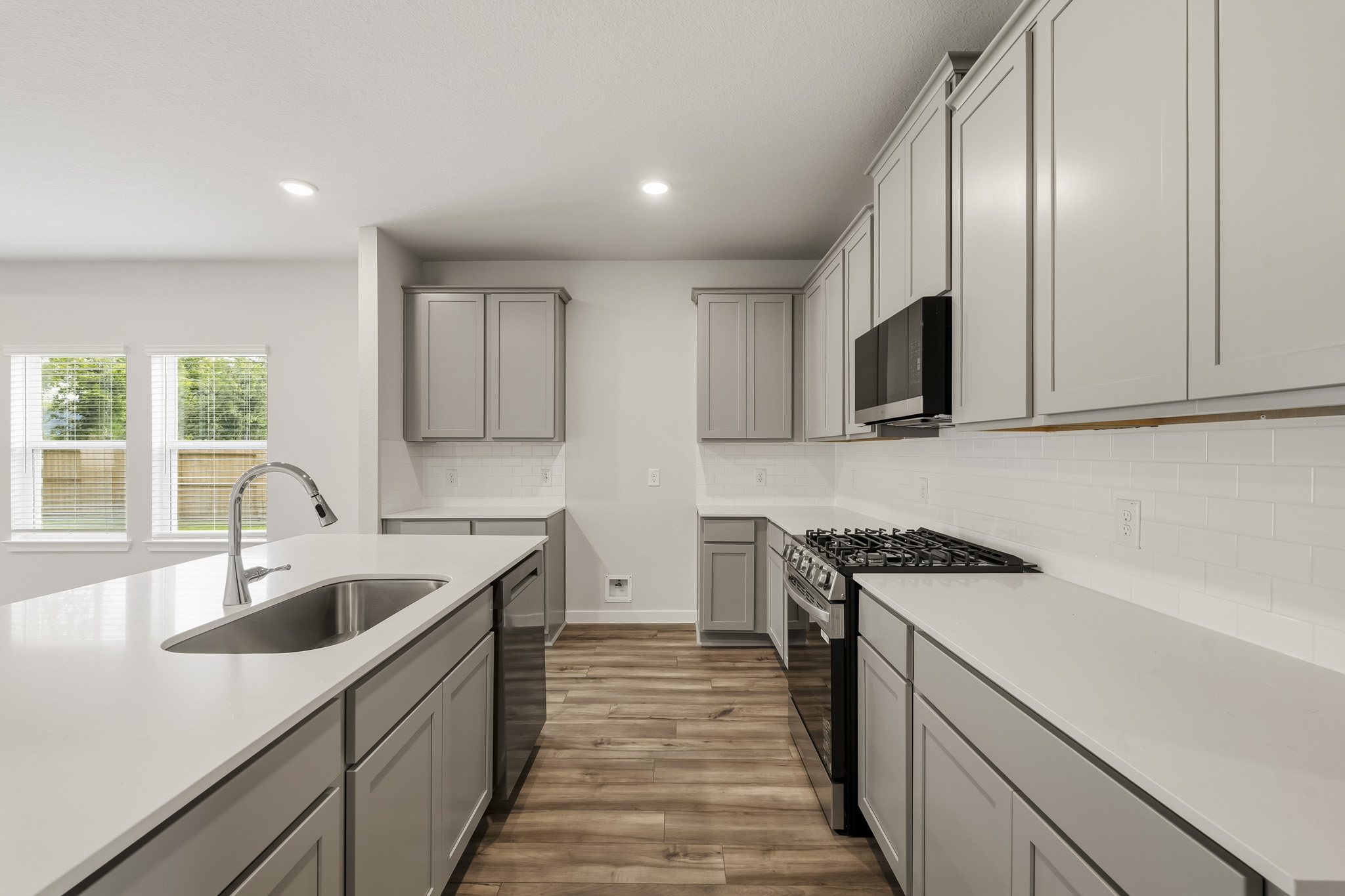 A kitchen with white cabinets.
