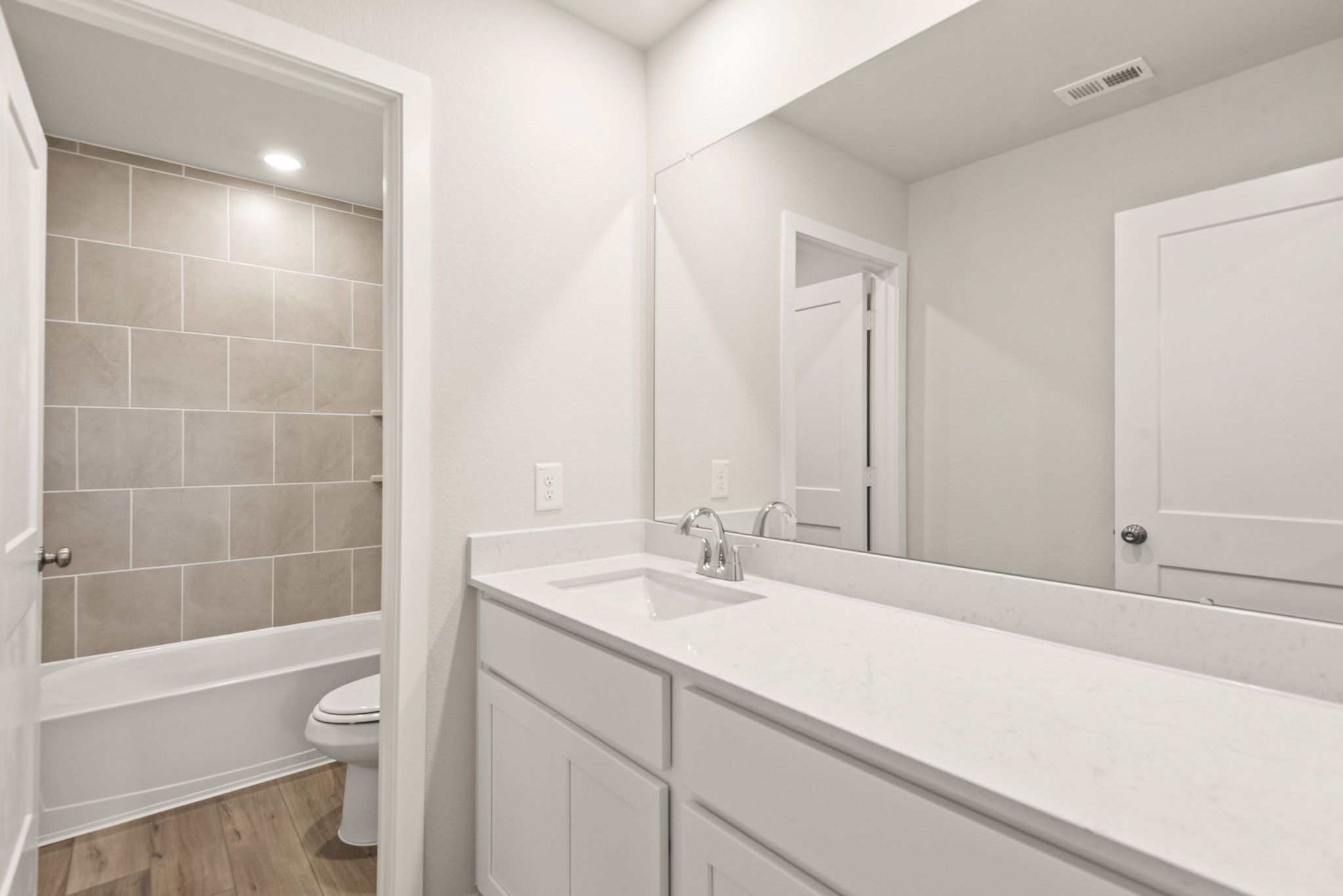 A bathroom with a tub sink and toilet.