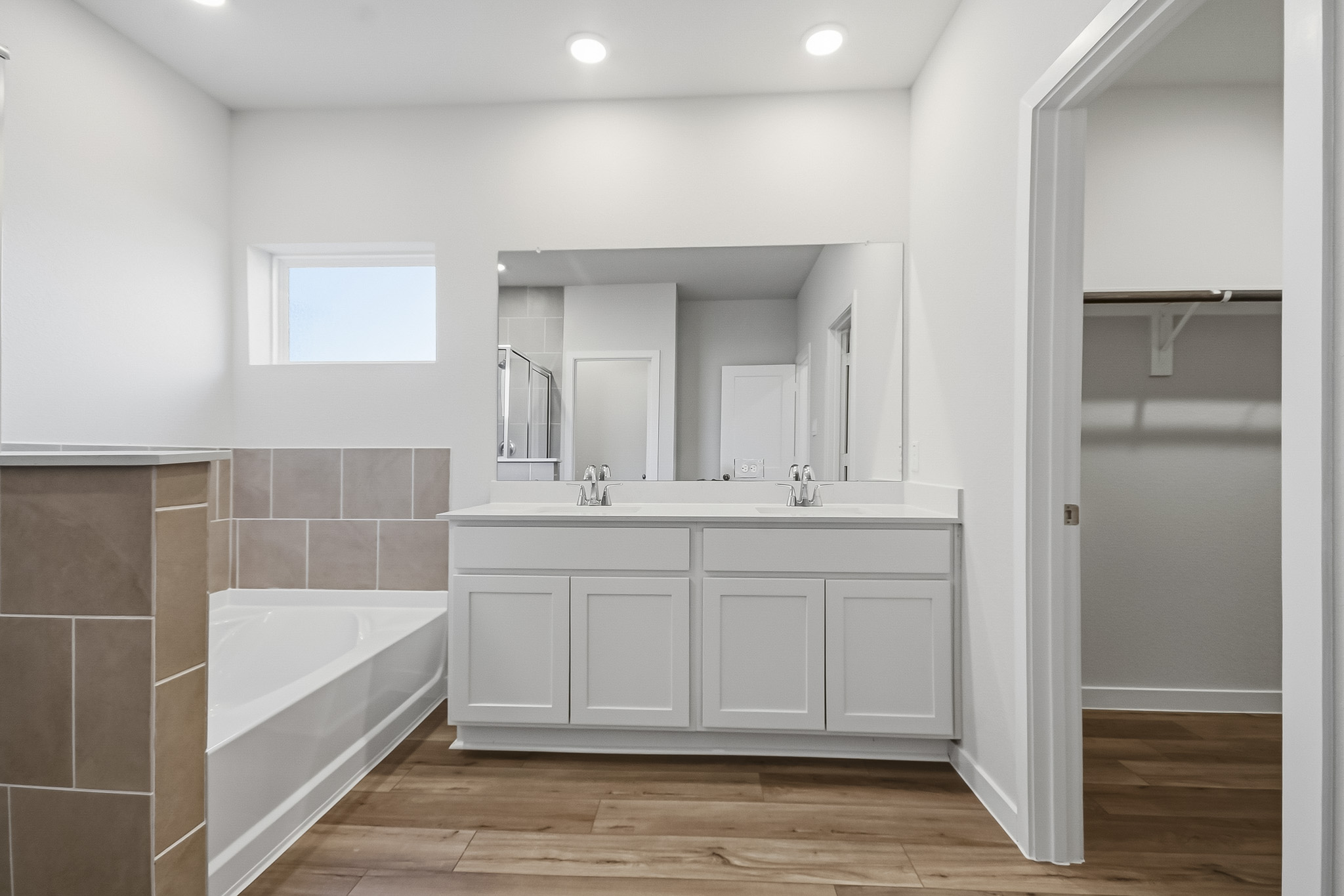 A bathroom with a tub and sink.