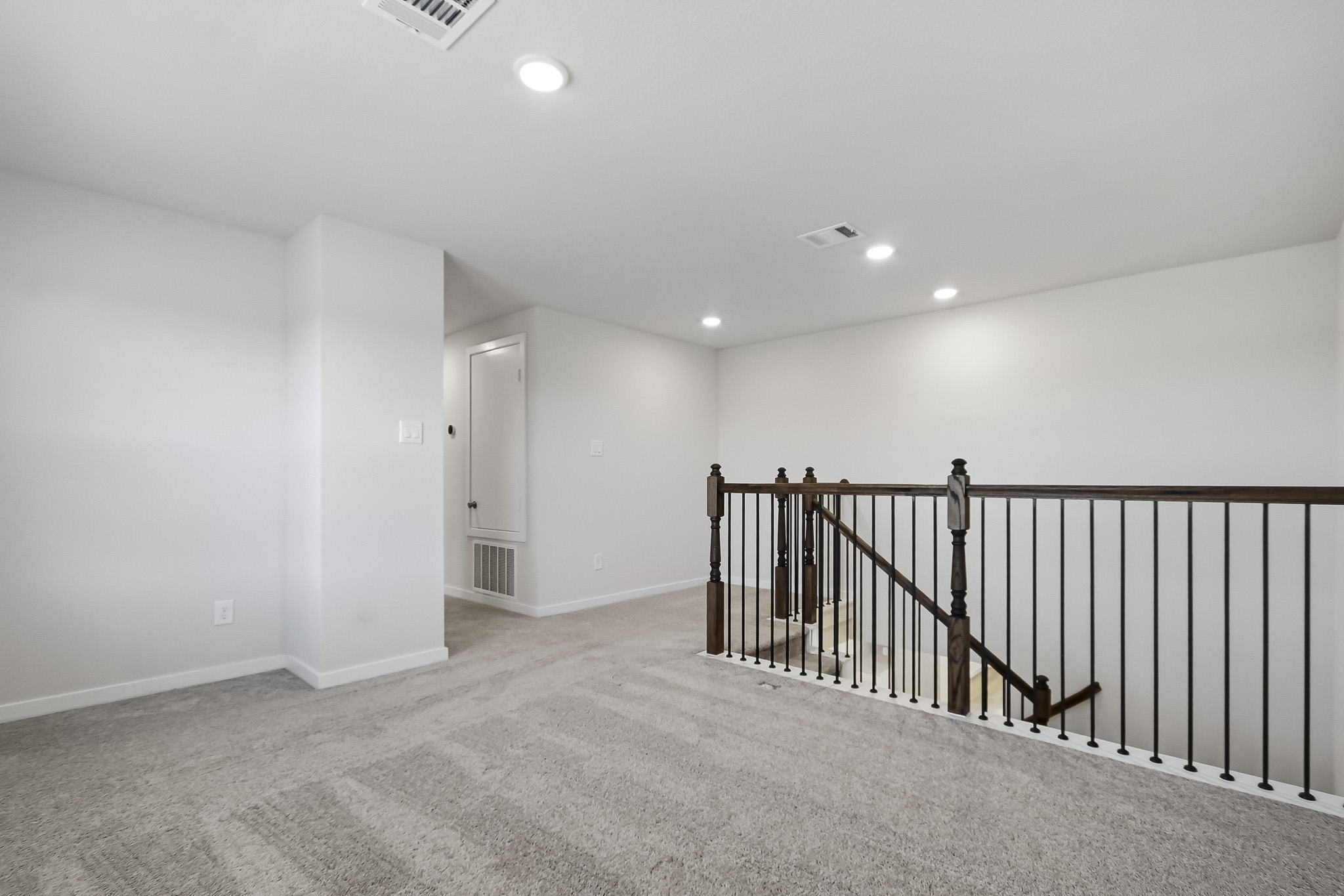 A hallway with a railing.