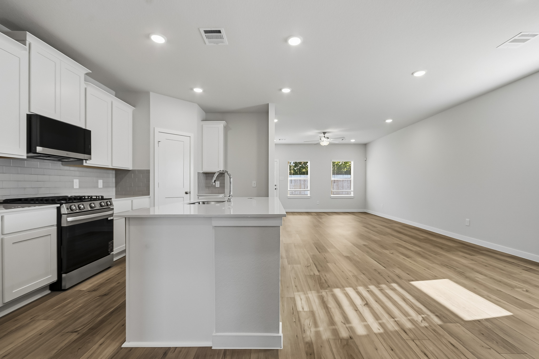 A kitchen with white cabinets.
