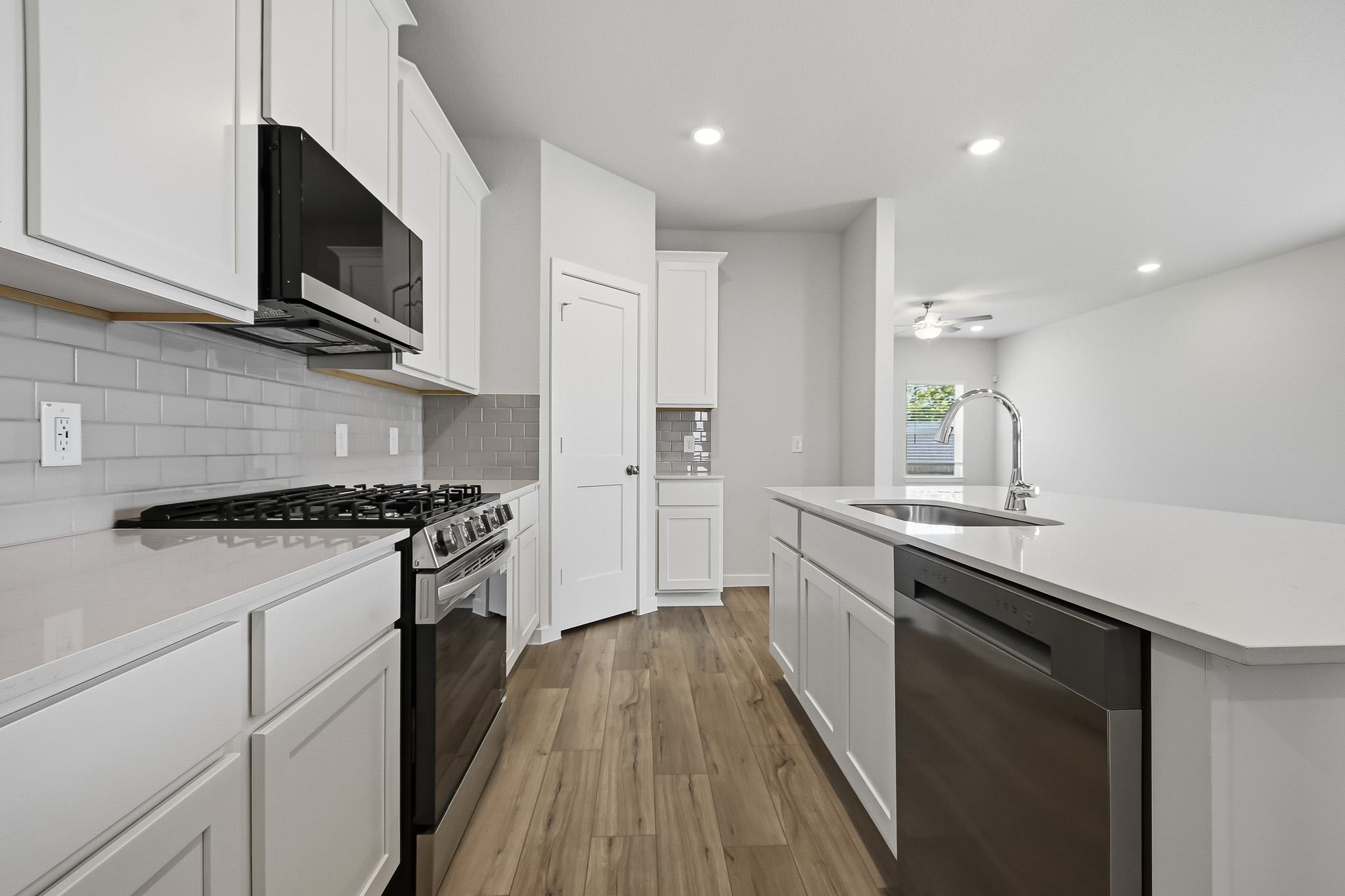 A kitchen with white cabinets.