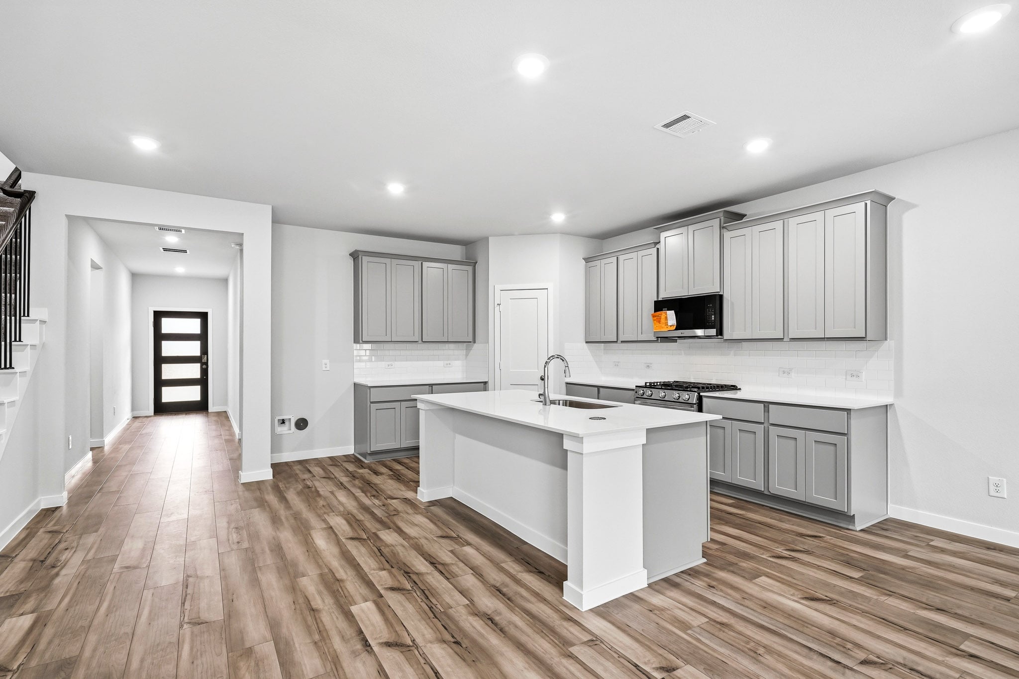 A kitchen with white cabinets.