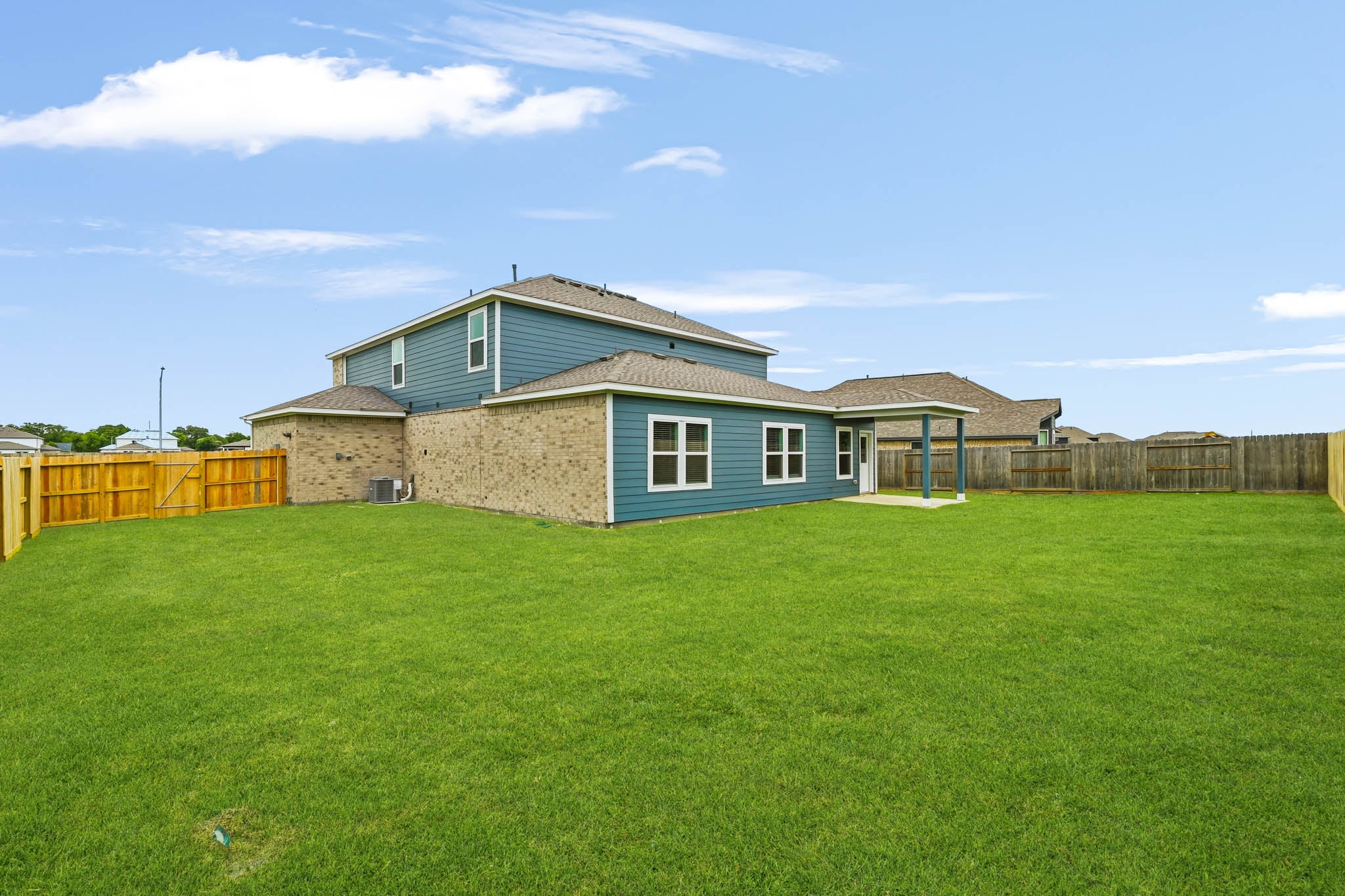 A house with a fence and grass.