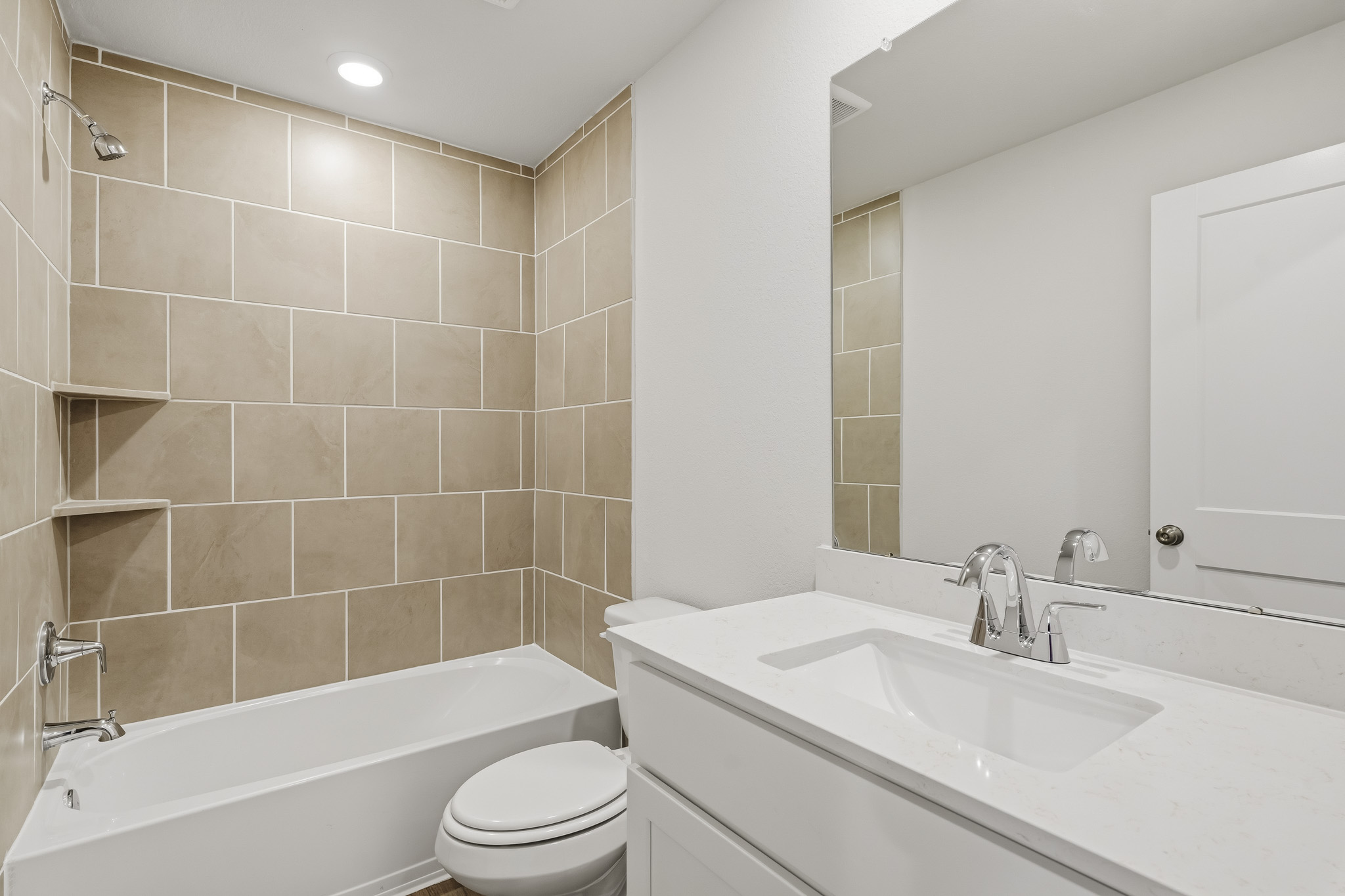 A bathroom with a tub sink and toilet.