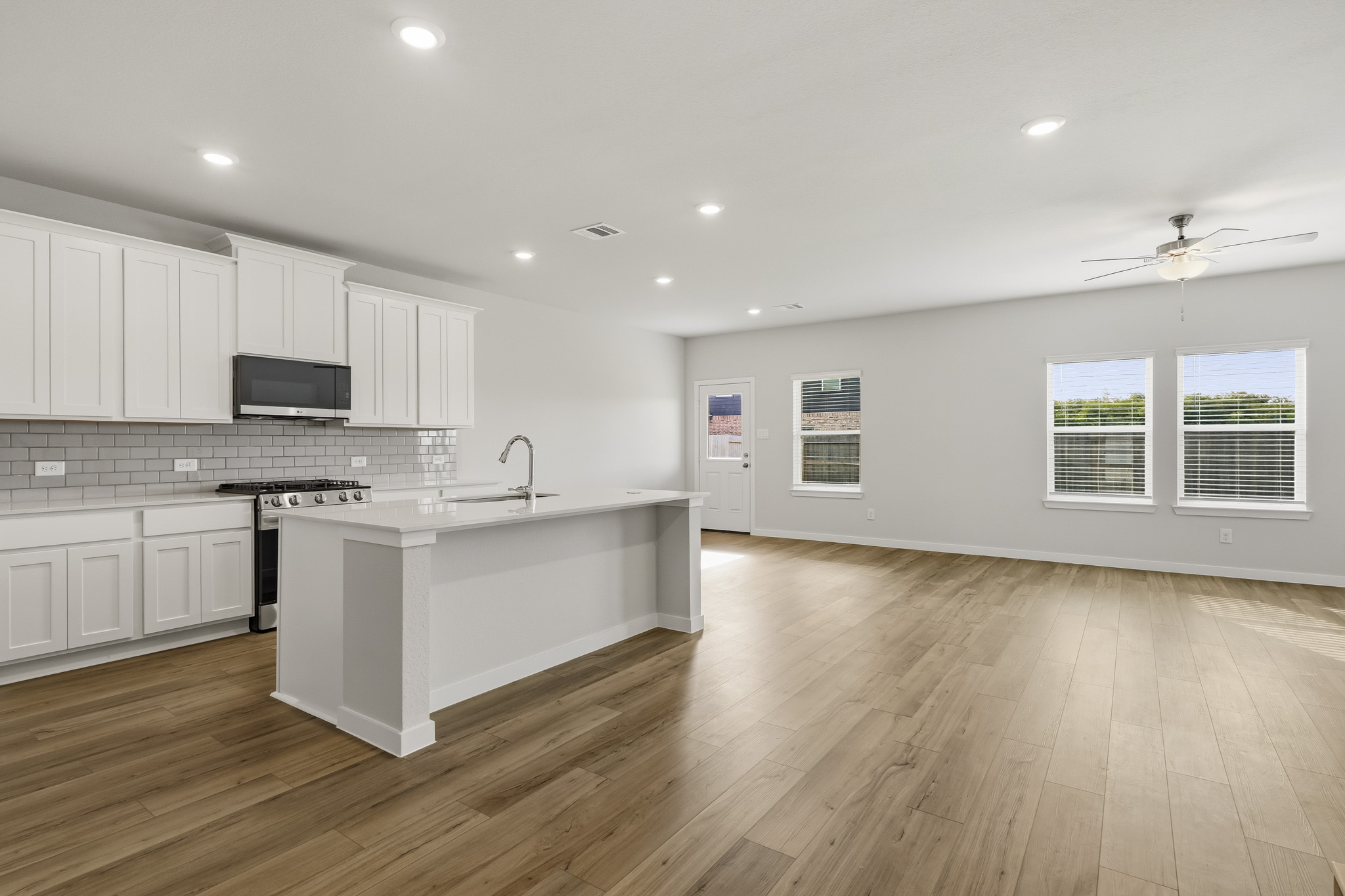 A kitchen with white cabinets.