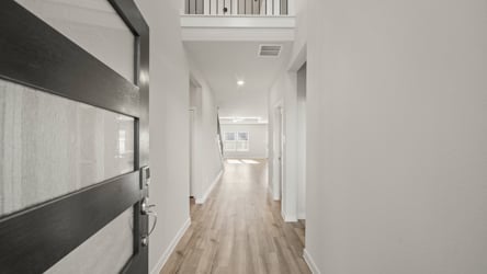 A hallway with white walls.
