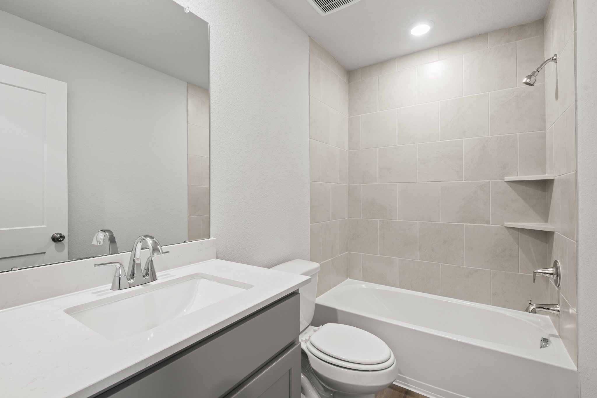 A bathroom with a tub sink and toilet.