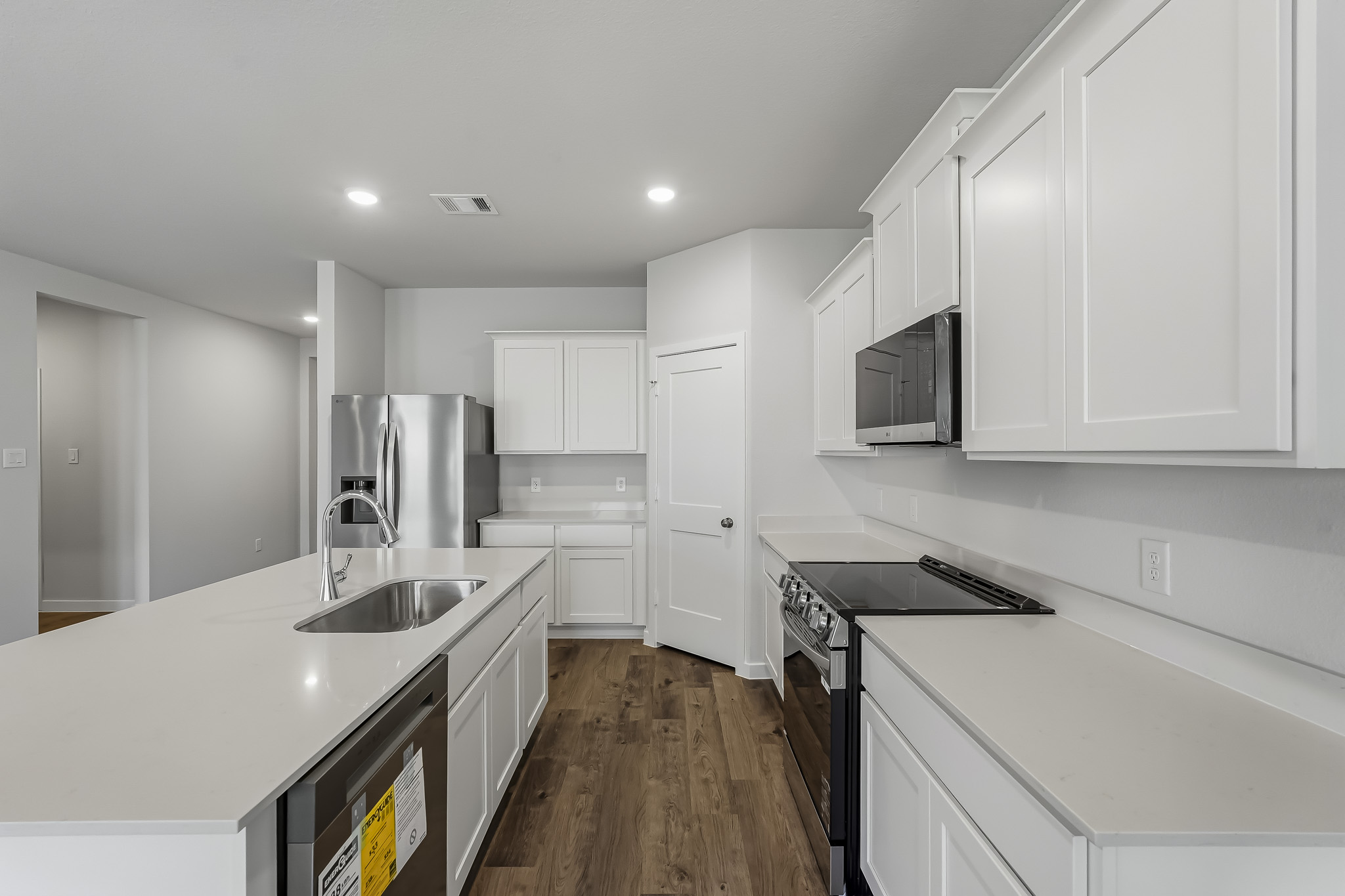 A kitchen with white cabinets.