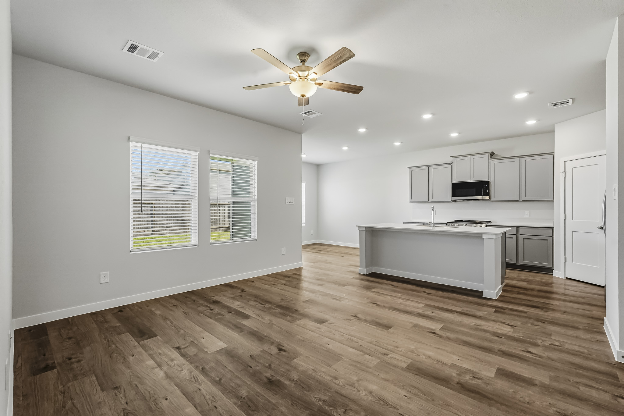 A kitchen with a wood floor.