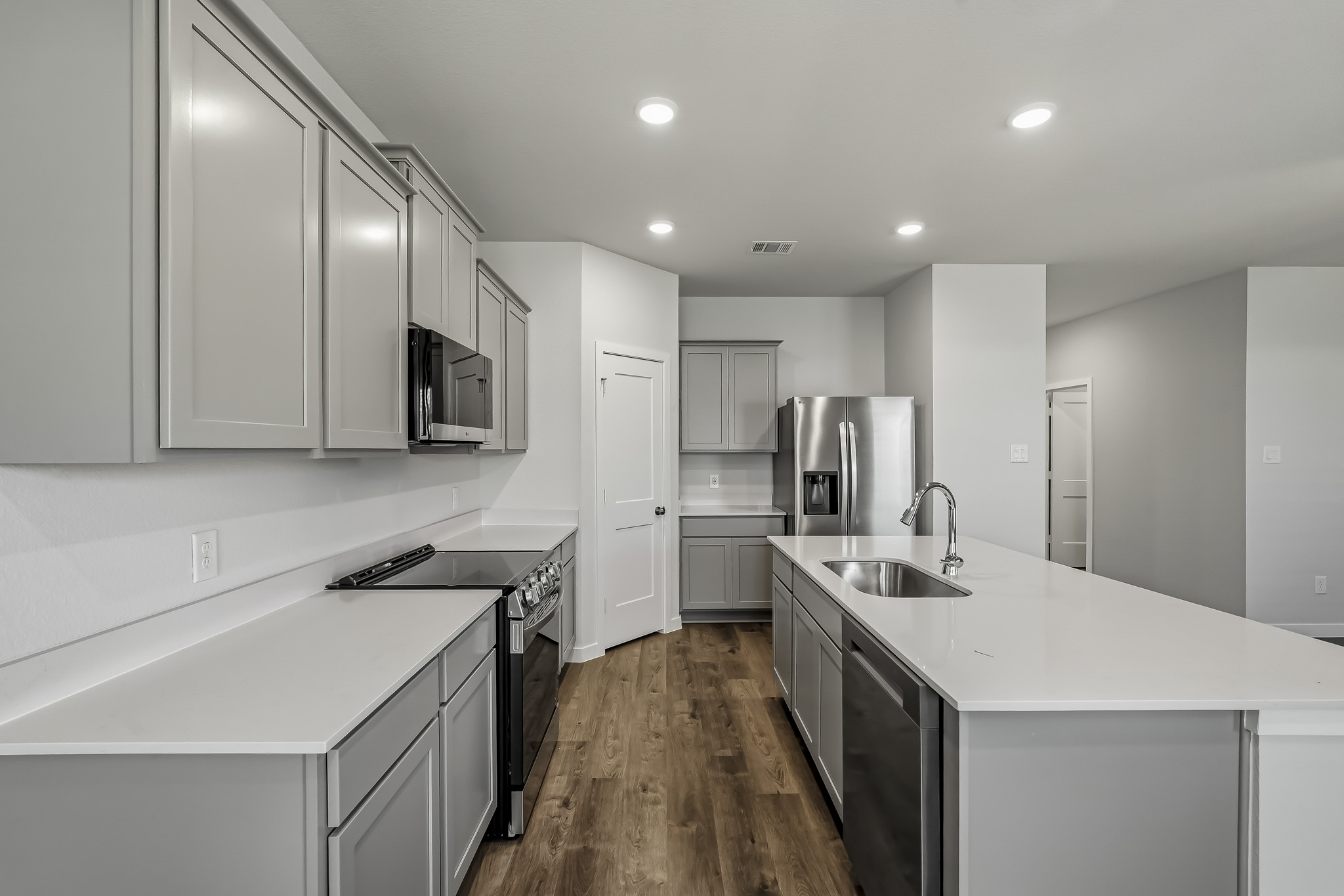A kitchen with white cabinets.