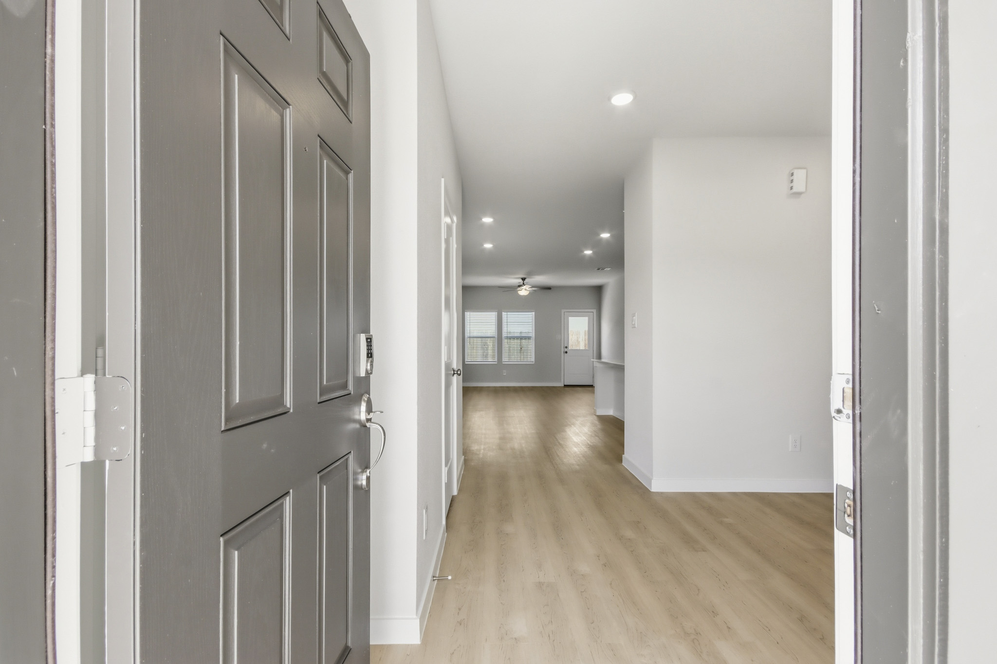 A hallway with white doors.