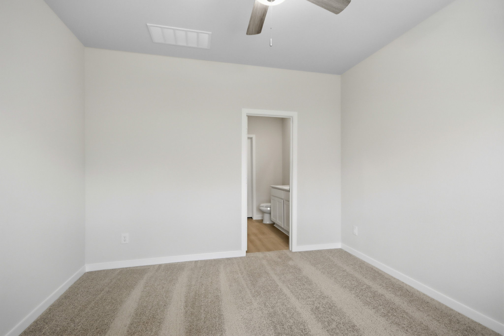 A room with a door and a carpet.