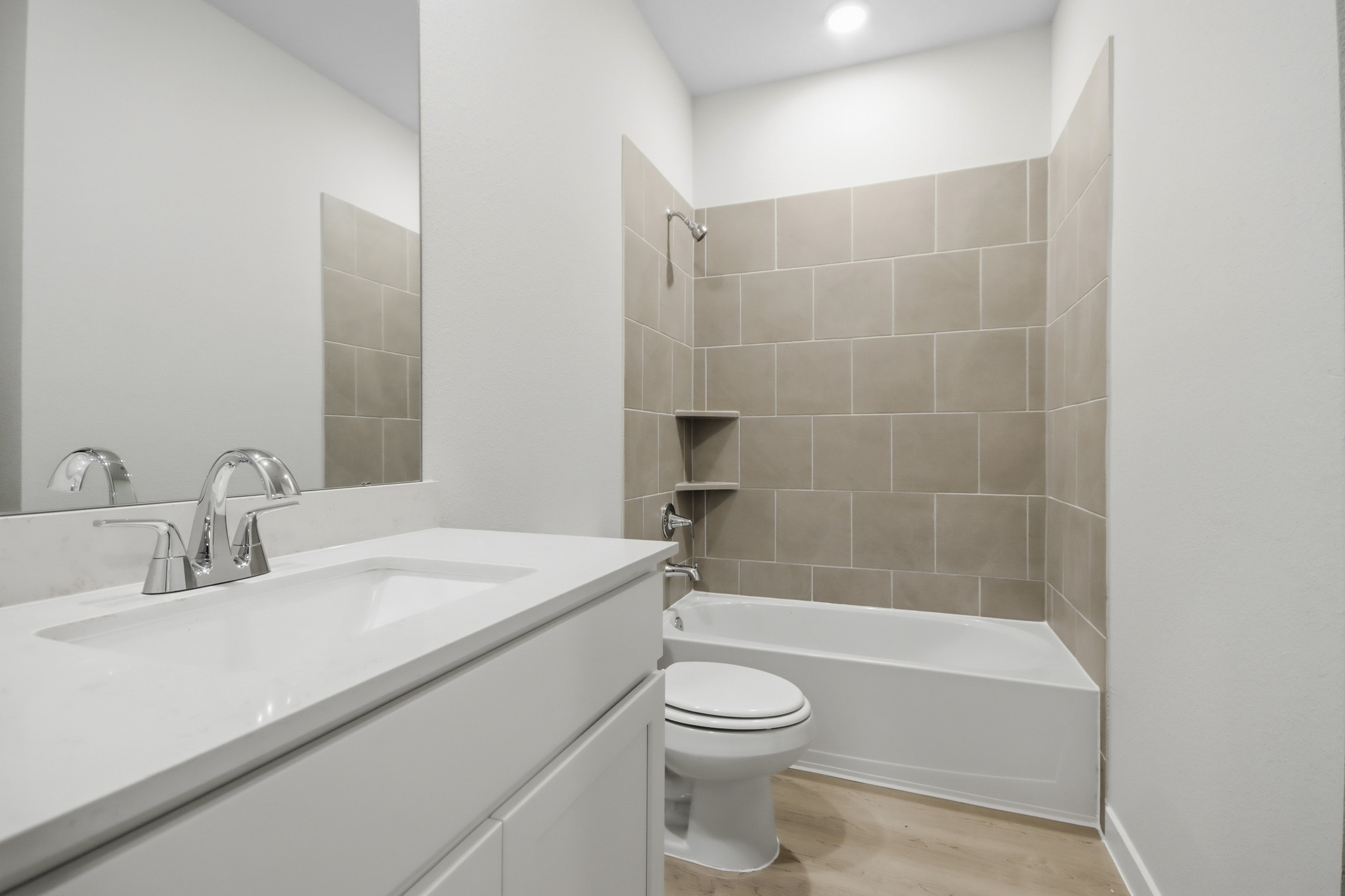 A bathroom with a tub toilet and sink.