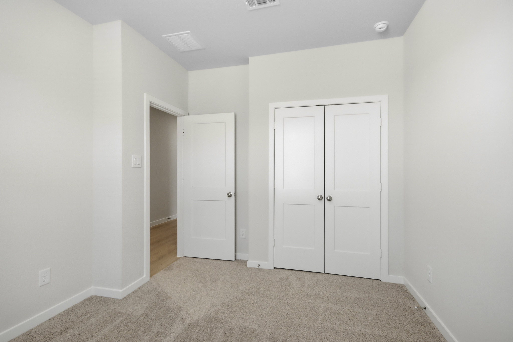 A hallway with white doors.