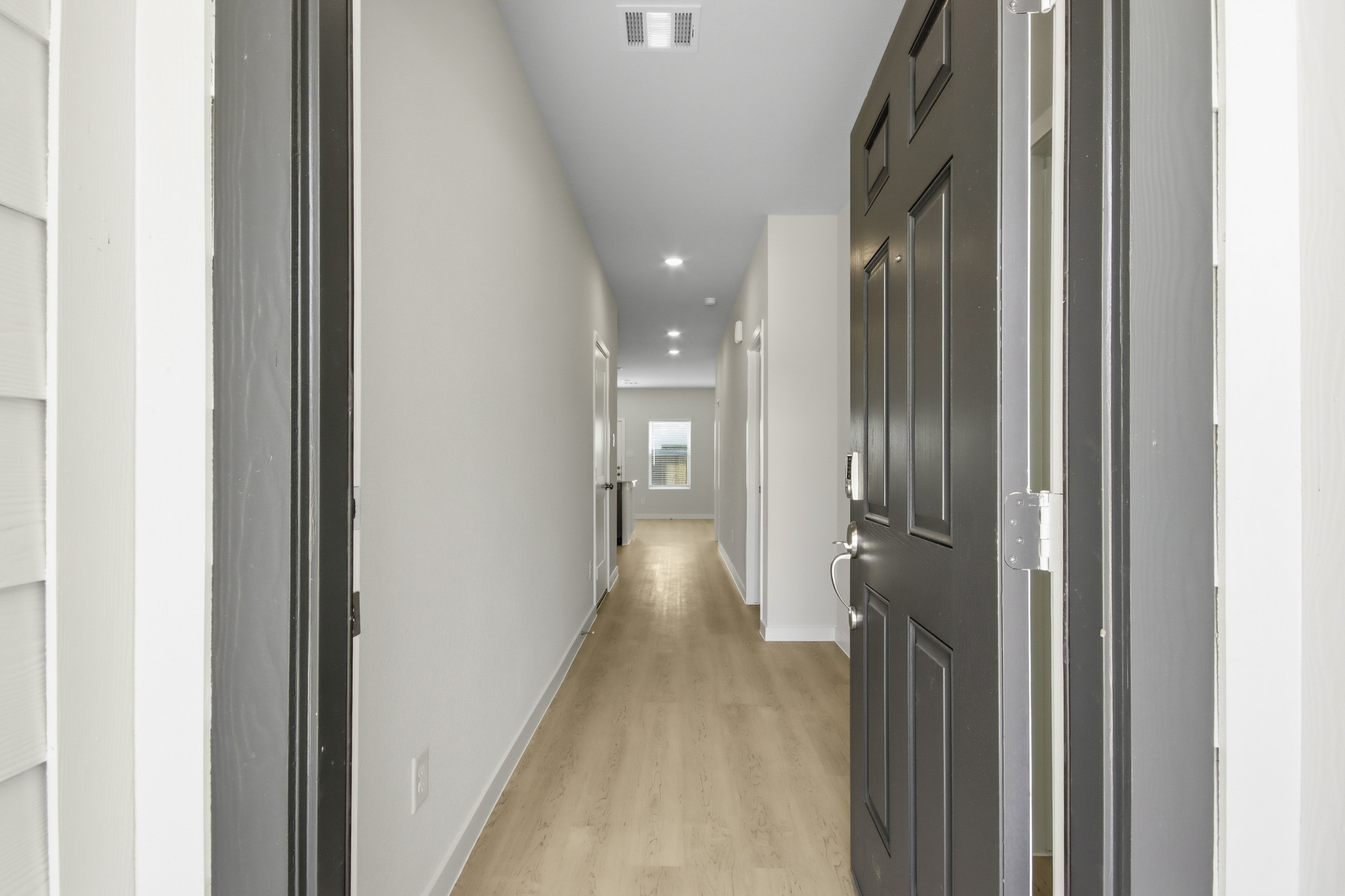 A hallway with black doors.