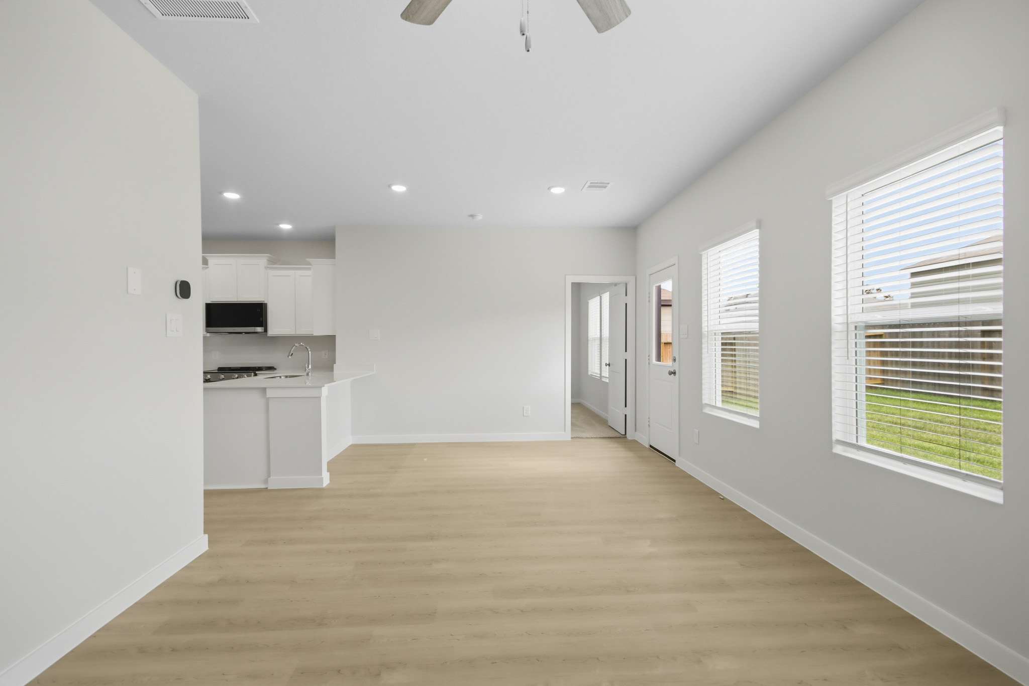 A kitchen with white cabinets.