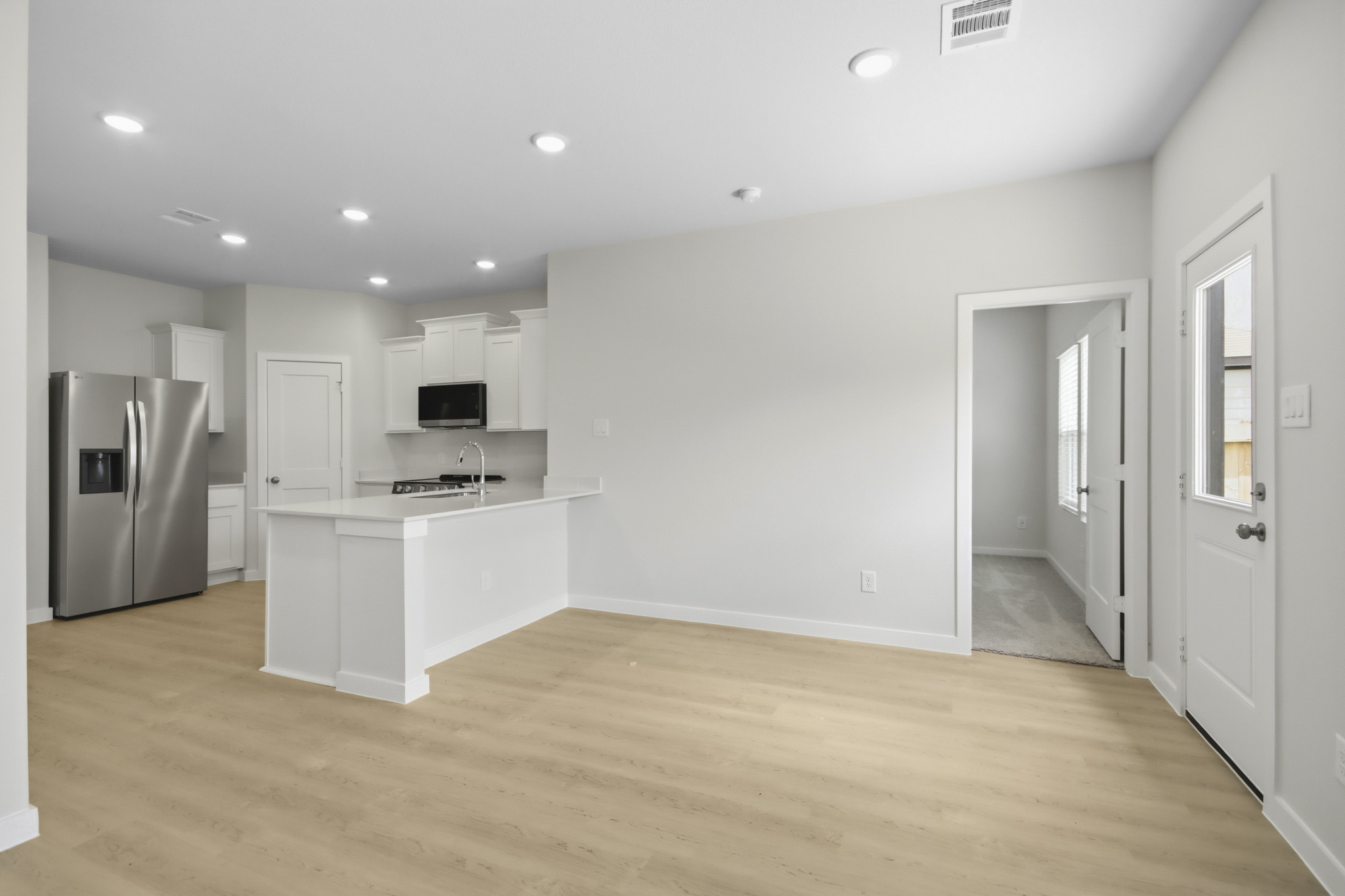 A kitchen with white cabinets.