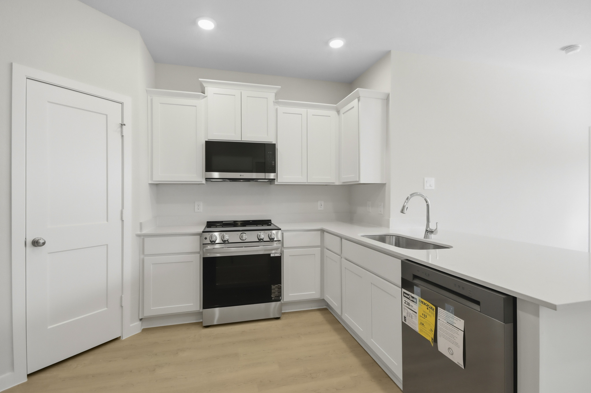 A kitchen with white cabinets.