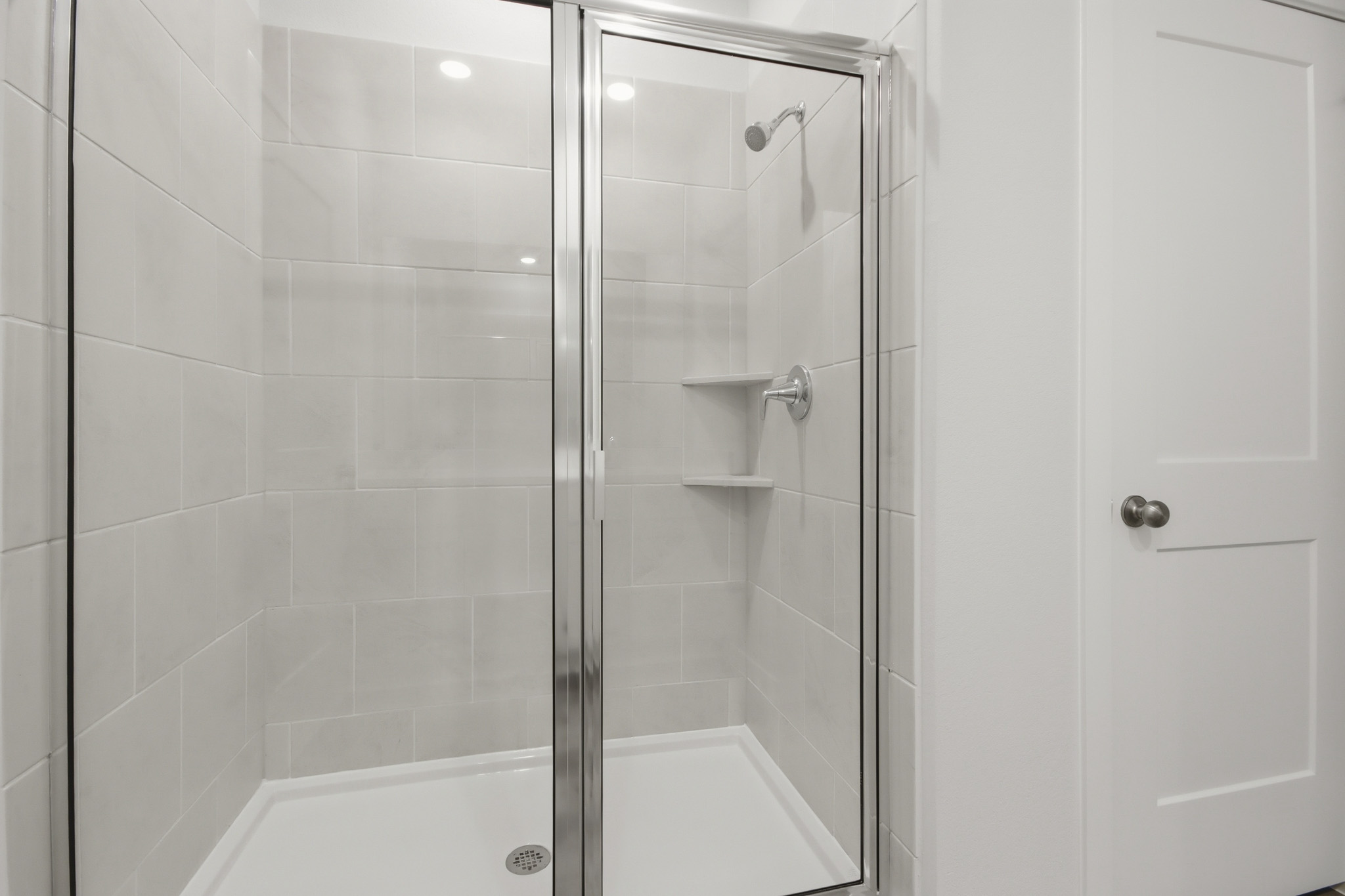 A shower with a glass door.